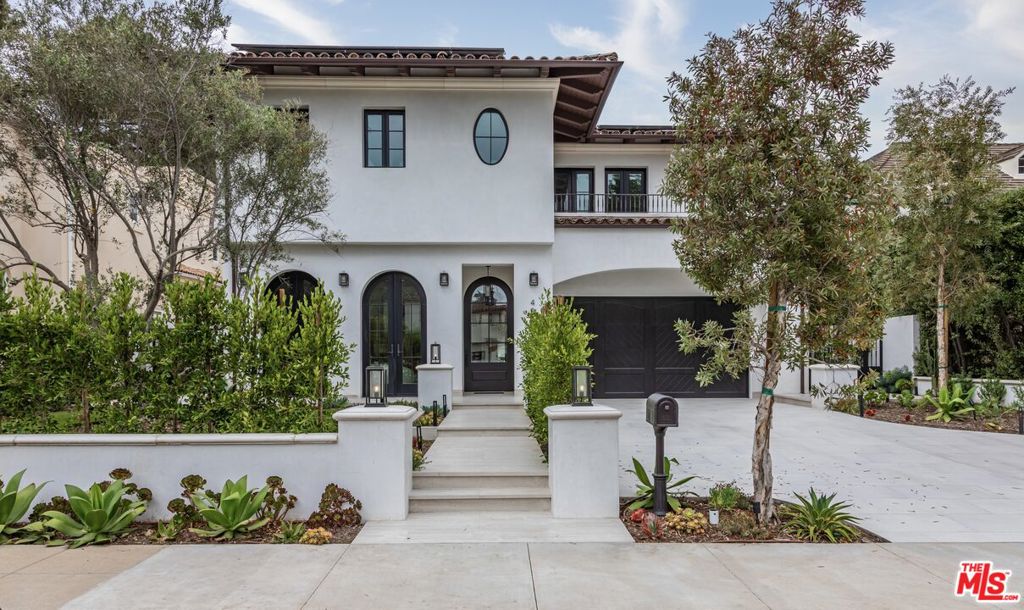 Set in the esteemed North of Montana neighborhood of Santa Monica on a nearly 9,000 SF oversized lot, this custom-built new construction blends quality craftsmanship with exceptional amenities and scale. Spanning 6,860 SF with 4 bedrooms + office and 7 bathrooms across three levels, this home delivers seamless indoor-outdoor flow and expansive spaces built for elevated living and entertaining. The main level offers soaring ceilings and expansive living spaces, including a formal living room, dining room, dedicated office, and an open-concept kitchen outfitted with bespoke cabinetry, butler's pantry, and Miele, Sub-Zero, and Wolf appliances. Fleetwood doors connect the interiors to a private backyard retreat featuring a heated pool and spa with automatic cover, a built-in BBQ and pizza oven, and multiple zones for dining and lounging. Upstairs, wide-plank oak flooring leads to three generously sized en-suite bedrooms, including a reimagined primary suite with a newly expanded oversized walk-in closet. The amenity-rich basement level includes a lounge and bar, movie theater, wine cellar, guest suite, and full spa with both wet and dry saunas. Mature ficus trees line the front of the home for added privacy and additional highlights include solar panels, multi-zone climate control, Control4 smart home system, and a three-car garage. Located just moments from Montana Avenue, San Vicente, and Brentwood Country Club, this home offers a rare opportunity to enjoy scale, privacy, and convenience in one of the Westside's most sought-after neighborhoods.