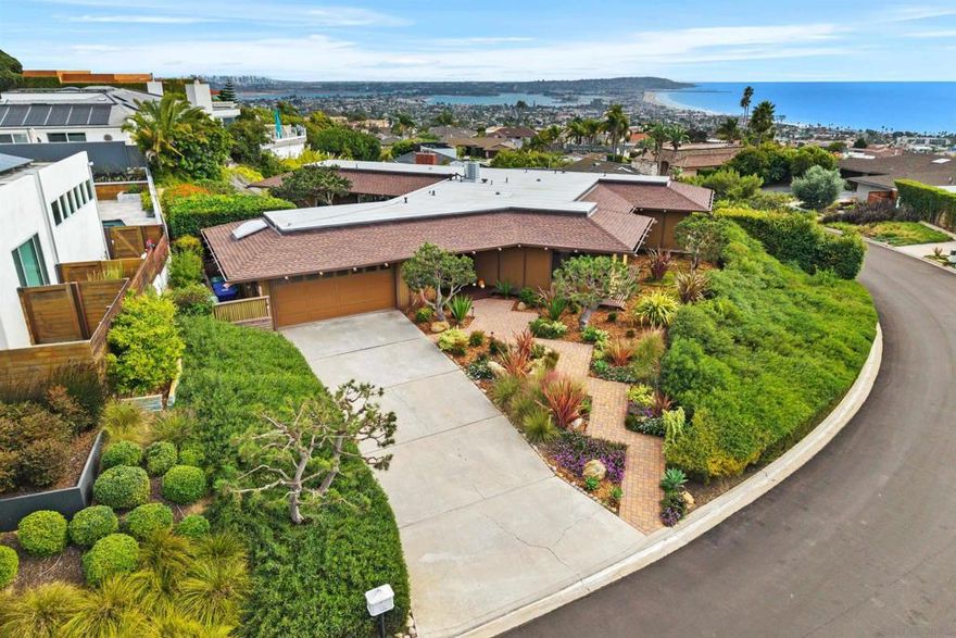 Experience spectacular panoramic bay/city/white-water south coast views and beyond from this stylish single level home in the coveted and sunny La Jolla Palisades neighborhood. Ideal orientation and flooded with natural light, 1970’s modern in design with Asian influenced architectural details and an open floorplan, this property offers easy indoor/outdoor living while enjoying year-round sunsets. The low maintenance landscape is adorned with flowering natives and Japanese black pines. Other features include an oversized utility/laundry room with a sauna and shower. Location is superb, within close proximity to the beaches, villages (LJ, PB, Bird Rock) and schools.  Recent improvements include: new roof and drains, high efficiency electric HVAC heat pump and AC system with new ducting along with new landscape and irrigation system.