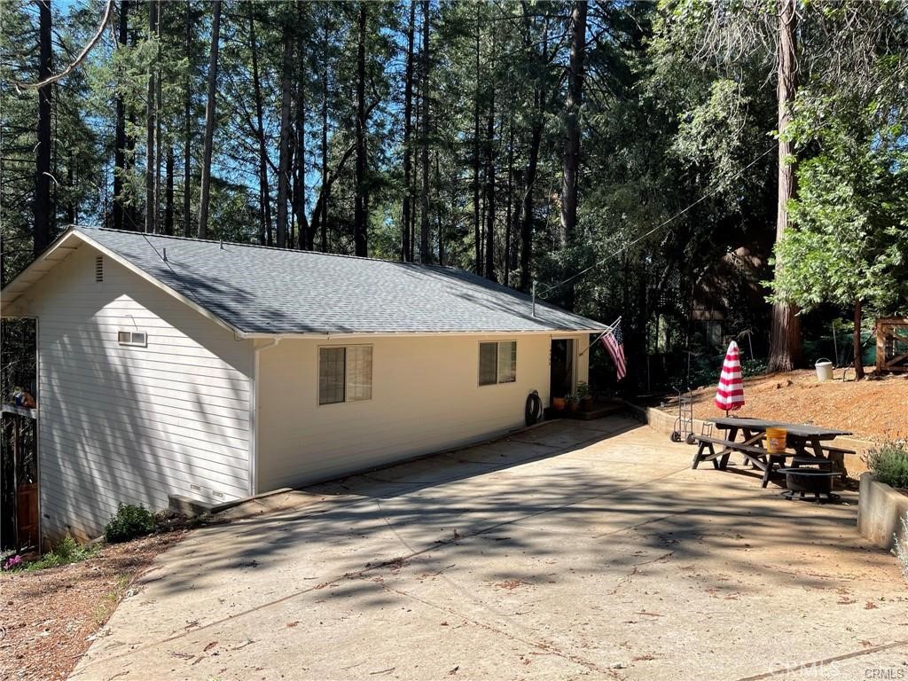 Come home to the pines! Charming home situated on large .76 acre lot is ready for it's new owner. Home is located within a FireWise Community for saving on fire insurance! Backed by greenbelt below and a walking trail-peace and tranquility await. Home features two bedrooms, one bathroom and an additional bonus room below the home-not included in the square footage. Large kitchen with separate dining area featuring sliding glass doors which open to a covered deck spanning the length of the home. Call to schedule a time to view today!