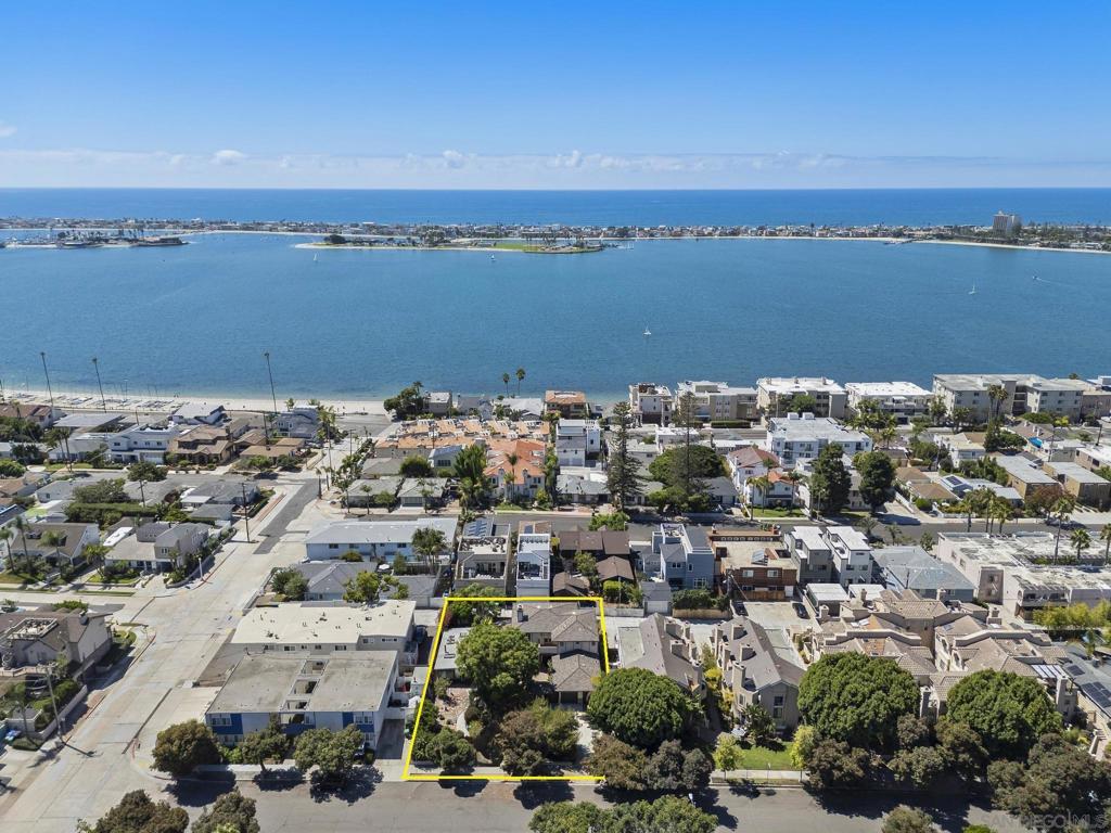Welcome to San Diego’s Crown Point, Sail Bay and Mission Beach playgrounds.. These iconic locales that trigger emotions of happiness in all of us, are here at your beck and call. Located a few minutes walk in any direction awaits the world of sailing, paddleboarding, Kayaking, volleyball, or sunrise and sunset walks. Introducing a residence conceived in a tropical dream and nestled in paradise. A custom-built home reflecting harmony and peace, as in the land of Shangri-La. Step through beautiful entry gates and enter a world all your own. Huge lots like this seldom come available this close to the water. The easy flowing floorplan integrates dramatic natural elements and free flowing spaces. The rooms are all spacious with intelligent design and the lot is grand in size, offering exceptional expansion possibilities. *See Supplement for Details* All the boxes get checked off with this house… We’ve already talked about the beauty and design, so let's dig into the function. First of all, you are at the beach.. So what could be better than onsite parking for up to 7 cars, and all in a most proper manner! Step inside and the majority of the 1st level is a great room featuring beautiful living and dining rooms, and an open concept chef’s kitchen. The home was constructed in 2005 and its fixtures, surfaces and spaces have stood the test of time. The kitchen is large with maximum granite counters featured in a “U” style peninsula. Plenty of storage and cabinetry and, most importantly, plenty of elbow space to work. There is also a fantastic laundry and utility room conveniently adjacent to the kitchen. There are two primary suites, with one on each floor. The main suite is upstairs and has wonderful features such as two outdoor terraces, fireplace and a big walk-in closet. The bath is luxurious with a shower big enough for a party, and a separate tub just beckoning for company. The secondary primary is on the entry level and features direct access out to the yard and spa. Its bath is also surprising with a grand shower and everything drenched in sunlight. There is also a large office on the first floor, powder room, 2nd floor guest suite and a wide staircase which fits the grand scale of the home. There is a rustic guest house on the property that is prime for remodeling or replacement. Buyers should consult directly with the City of San Diego Building Services, however, we believe the property is zoned RM-1-1. This zoning would allow 1 unit per 3,000sf of space, which should give this lot a total of 3 main units. The City of San Diego also allows 2 ADUs “By Right” for a RM, and the Floor Area Ratio (FAR) for this location appears to be 75%, giving the ability to have 6,525sf of total livable space, inclusive of the main house (once again, Buyers are responsible to VERIFY ALL). What does this all mean? Well, with the convenience of being located on a lot that also features an alley, someone could add 3,500 +/- SF with 2 additional units and 2 ADUs for maximum utility. Keeping the existing house and adding up to 4 more units could create the residential beach compound of a lifetime! Bottom line, the possibilities are vast.