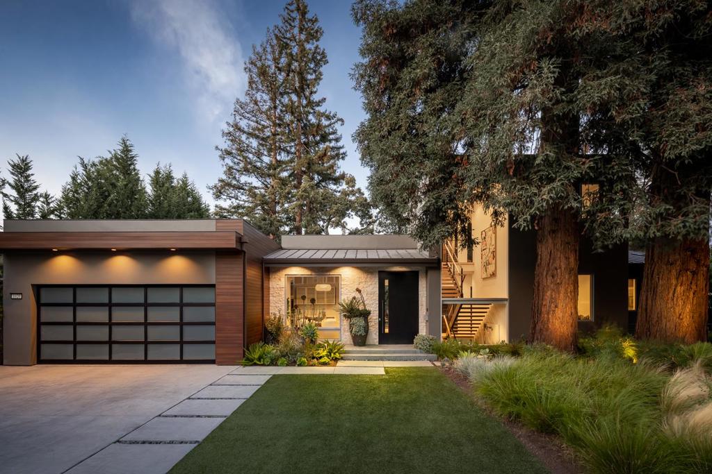 Bold in design while retaining a sense of familial warmth, this sensational residence on an iconic street was crafted with an uncompromising eye for detail and volume. Entering through the striking pivot door, you encounter the first-floor public rooms, including a formal dining room, great room with soaring ceilings, and pristine chef's kitchen with a 14-foot Calcutta marble island and Sub-Zero and Wolf appliances. Tucked behind double doors, the owner's suite is your personal sanctuary with gas fireplace, bathroom with Porcelanosa fittings, and customized walk-in closet. A floating staircase leads you to the top level with a private rooftop deck, or down to the basement with a suite of rooms for entertaining, including a home theater, family room, game room, exercise studio, and wine cellar. The yards are lushly landscaped with fire pit and water features. Details such as radiant heated floors, a living wall, art niches, and elevator place this home in its own class.
