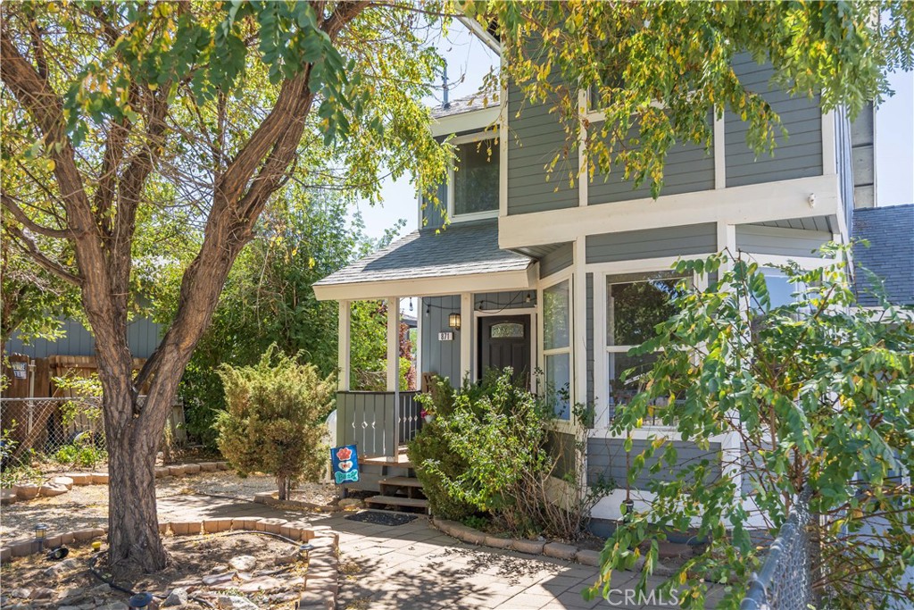 Welcome to this comfortable and spacious family home, and spend your days looking out to the mountains and big skies of Erwin Lake, Big Bear City. This family home has been lovingly maintained, and is positioned on a double lot - with street to street access. Paved level driveway attached garage with a heating unit makes storage and parking comfortable all year round. Arriving home here means a cosy and inviting front garden offering privacy and seclusion, along with a fenced in front yard. A perfect location for an affordable home for the outdoorsy family. Close to hiking, mountain biking, and horseback riding, the home has been landscaped with drought resistant plants and is completely fenced in - this home also includes the additional vacant lot which provides for a huge back garden and all fully fenced into one big yard. Inside, the home is clean and comfortable with natural light flooding into a pretty bay window bay dining space, gorgeous wood ceilings downstairs, and a spacious open kitchen with laundry inside. Off the living area is comfortable, full sized bathroom. Upstairs are the spacious bedrooms, the primary is oversized and includes an alcove home office / nursery area with views out to the landscaped entryway, a second spacious bedroom across the hall, with both bedrooms having jack and Jill access to full bathroom. The back yard looks out to a pretty mountain landscapes, and in addition to the oversized yard, there are fruit trees and a storage shed. This place is easy to call home, with friendly family neighbors of both the human and burro variety :)