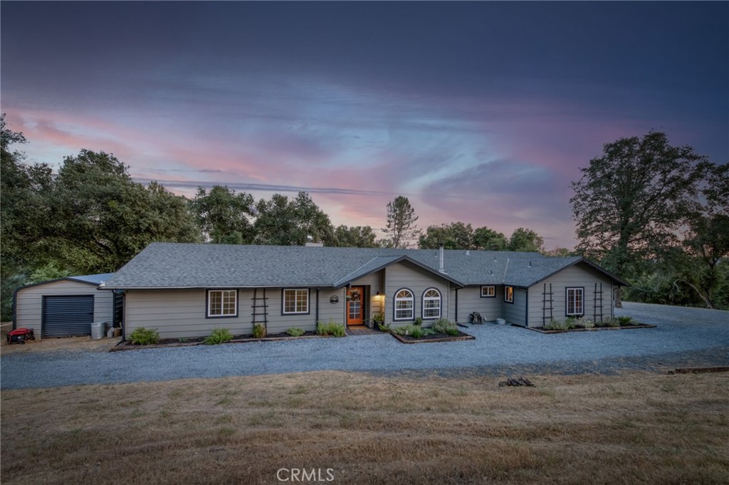 Live the designer's dream in this thoughtfully curated mountain retreat just minutes from downtown Oakhurst. Set on a super-private 9-acre lot, this 4-bedroom, 3-bathroom home beautifully blends modern updates with rustic mountain charm, offering over 2,100 sq. ft. of carefully renovated living space.
Step inside to discover brand-new flooring throughout, a completely redesigned kitchen with newer appliances, and updated bathroom vanities. The new front door and slider add fresh style and function. Vaulted ceilings, expansive windows, and dramatic natural light create an open, airy ambiance perfect for both relaxing and entertaining.
Off the living room, you'll find a versatile bonus space featuring a built-in TV above an electric fireplace, plus a stylish bar ready for your next craft cocktail. Outdoors, enjoy a covered concrete patio complete with a built-in fire pit and bar area, overlooking a gently sloping yard and peekaboo views of Deadwood Mountain framed by mature trees.
Additional features include a Tesla Powerwall battery system for energy efficiency, freshly graveled driveway, reverse osmosis water purification system and turnkey condition throughout.
This is more than a home, it's a lifestyle. Come experience the perfect balance of privacy, modern design, and mountain living. You'll feel like you've stepped into a magazine!