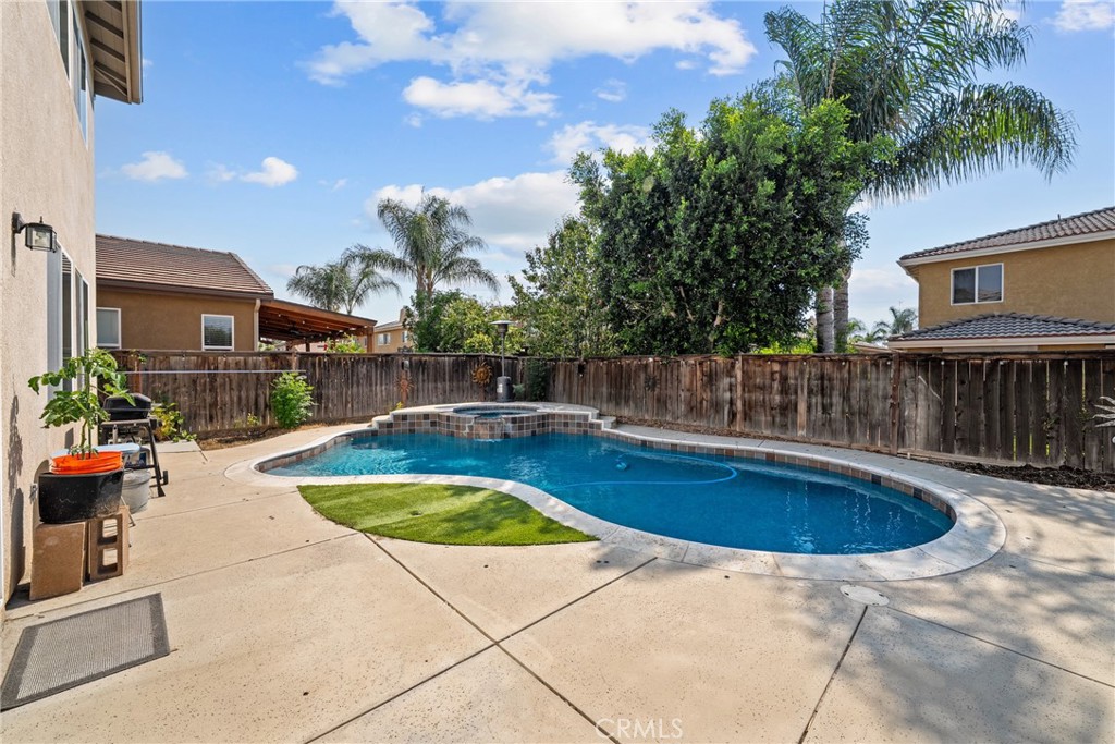 Highly desirable Dutch Village community of Winchester, this beautifully maintained home offers over 2,200 square feet of living space with 6 bedrooms, 3 bathrooms, and a spacious 2-car garage with paid off solar. Located just minutes from schools, parks, shopping, and dining—and within the Temecula School District—this property is ideal for anyone seeking comfort, convenience, and community. Charming curb appeal and lush landscaping set the tone as you enter. Inside, you’re welcomed by a light, neutral paint scheme and laminate flooring. The open-concept kitchen is the heart of the home, offering granite countertops, oak cabinetry, under-cabinet lighting, and stainless steel appliances. It flows seamlessly into the dining area and family room, which is bathed in natural light and features a cozy fireplace for relaxing evenings. With two bedrooms and one full bath on the first level it is perfect for multi-generational living. The primary suite is on the second level generously sized and privately tucked away, with ensuite private bathroom offering dual sinks, a separate vanity area, jetted soaking tub, glass-enclosed shower, and a huge walk-in closet. Outside, enjoy a versatile backyard space with a mix of concrete patio, green lawn, and mulch landscaping—perfect for entertaining or quiet outdoor living. Just one street away from Primrose Park and close to everything you need.