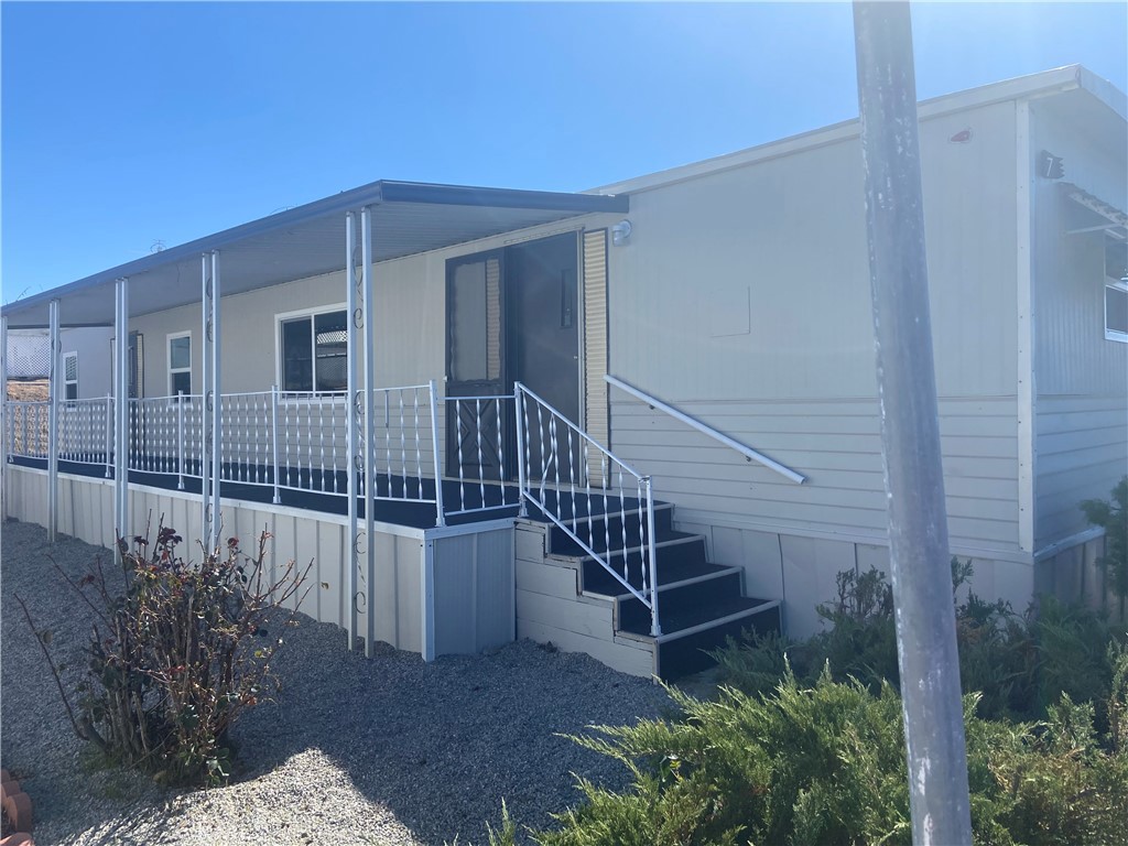 Cozy and fully remodeled 2 bedroom and 1 bath Mobile Home for 1-2 people. Step into a like-new mobile home, thoughtfully updated with modern finishes and enhanced comfort. This completely remodeled space features brand-new carpet and flooring throughout, freshly painted walls, stylish new cabinet doors with updated hardware, and a welcoming kitchen with new countertops and sink. The bathroom has been beautifully refreshed with a new vanity and toilet, ensuring a clean and contemporary feel. All windows have been upgraded to double-pane for better insulation and energy efficiency. A brand-new AC and mini-split unit with remote control keeps the home comfortable year-round. Enjoy outdoor living in the large, covered patio/porch area, freshly carpeted and rebuilt for safety. The property includes a carport with space for three vehicles. Nestled in the quiet back area of the park with no through traffic, this home offers peace and privacy while being conveniently close to community amenities, including a recreation center and pool. This is a 55+ Community and a must-see.