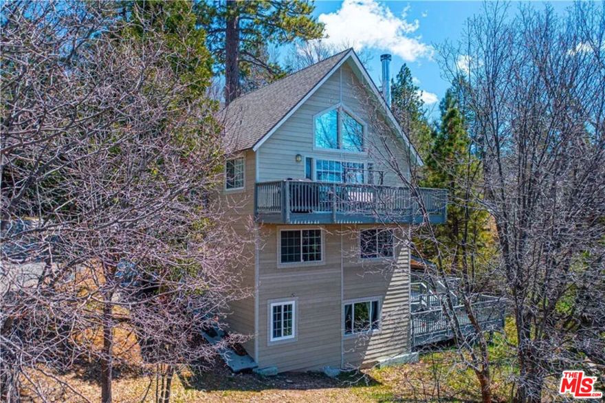 Now available for lease, this charming Lake Arrowhead home offers beautiful mountain views, spacious indoor living, and exclusive lake rights for year-round enjoyment. The main level features an open-concept layout with a cozy living room, vaulted wood ceilings, large windows that let in plenty of natural light, and a classic rock fireplace. The kitchen and dining area flow out to a large deck perfect for relaxing or entertaining in the fresh mountain air. Downstairs, you'll find three generously sized bedrooms and two bathrooms, along with an indoor laundry area for added convenience. Multiple outdoor seating areas provide the ideal setting for dining al fresco, morning coffee, or simply unwinding under the pines.