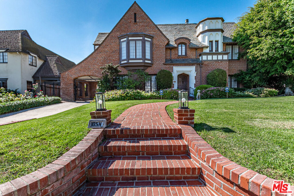 Timeless Tudor Charm with Modern Comfort in a Prime Tree-Lined Setting. This beautifully updated English Tudor blends 1920s elegance with the ease of modern living. From the moment you step into the gracious entry and take in the sweeping staircase, you'll feel the character and charm that make this home special. The sun-filled living room flows effortlessly into a spacious family room with a cozy fireplace and French doors that open to a lush, private backyard. The newly remodeled kitchen is a chef's dream, featuring high-end appliances, generous counter space, and abundant storage. A formal dining room adds the perfect touch for entertaining. Downstairs, you'll also find a guest powder room and a maid's room with its own en-suite bath ideal for guests or flexible use. Upstairs, the expansive primary suite offers four large closets, lovely natural light, and a spa-like bath. Three additional bedrooms and two updated bathrooms provide ample space, while a separate home office overlooks the landscaped yard. Step outside to enjoy gated grounds complete with a sparkling newly resurfaced pool, a dining patio, grassy play area, and a detached two-car garage with extra storage. Central air and heat ensure year-round comfort, and all the original character, hardwood floors, vintage details, and architectural charm remains intact. This is a home that feels both stylish and welcoming, located on one of the neighborhood's most desirable streets. Fireplaces are decorative and no credits will be given should they need any repairs. Co-Listed with Nussen Nagel