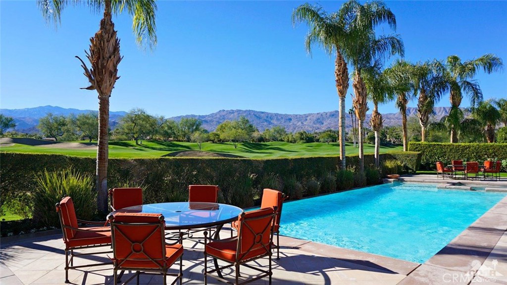 This truly remarkable custom home exudes the essence of luxury in refined living. Spectacular un-obstructed views of the Desert Course's 4th fairway, sand-traps and mountains beyond can be enjoyed from this sunny southern orientation. A custom residence with its architectural design focused on elegance and simplicity, this all one level floor plan includes 3 spacious guest suites, each with en-suite bath, and a master retreat with separate his and her baths. The formal entry leads to the living room with focal point fireplace, the magnificent formal dining room, and the guest powder room. The spacious family-style kitchen includes a breakfast area, counter seating and a gourmet-style center-island enhanced by quality appliances. A hobby room, large laundry room and a media room with office niche (or optional 5th bedroom) complete the spaces within the home's interior. Home is offered furnished per inventory.