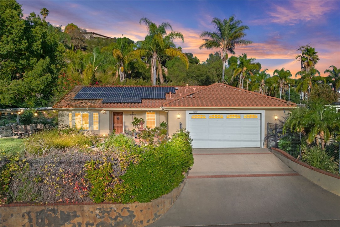 Welcome to 25703 Willow Lane in Escondido—a stunning single-story retreat that blends modern luxury with serene outdoor living. Beautifully remodeled from top to bottom, this 3-bedroom, 2-bathroom home sits on a spacious lot filled with lush landscaping, multiple fruit trees, and a private butterfly and hummingbird sanctuary, creating the perfect balance of comfort, function, and natural beauty.
Step inside to an open, light-filled floor plan where luxury wood-look vinyl flooring flows seamlessly throughout the living spaces. At the heart of the home is a true chef’s kitchen, thoughtfully designed with quartz countertops, a full marble backsplash, custom cabinetry, and an oversized island perfect for gathering. High-end stainless steel appliances(Viking, Wolf, and Bosch) include a built-in steam oven and a plumbed coffee maker—no more refilling water to brew your morning cup. Soft-close cabinetry, pull-out shelving, an RO system, and built-in trash round out this stylish yet practical space. And not to mention, gorgeous double french doors leading to the patio offering a seamless flow!
Designed with entertaining in mind, the kitchen features a pass-through window to the expansive outdoor patio. Here you’ll find a built-in BBQ island, outdoor TV, cooling fans, and custom lighting—everything you need to host family and friends in style.
The primary suite is a true retreat, complete with a custom walk-in closet, spa-inspired stone shower, and private access to the backyard. Two additional bedrooms and a second full bathroom provide space for family, guests, or a home office.
This property is not only beautiful but efficient. Owned solar keeps utility costs low, while abundant storage throughout the home makes organization easy. Outdoors, the amenities continue: a greenhouse for plant lovers, fenced dog areas, multiple storage sheds, and a fully insulated/electrified workshop perfect for hobbies, projects, or additional storage needs. With two areas with RV hookups and plenty of room for multiple vehicles and toys, this property is as functional as it is inviting.
Soak in peaceful mountain views from your front and backyard sanctuary, and experience the best of California living—all in one incredible property. Equip with a full working greenhouse.
25703 Willow Lane isn’t just a house—it’s a lifestyle. With thoughtful upgrades, smart features, and endless possibilities for entertaining, relaxing, and creating, this home truly has it all.