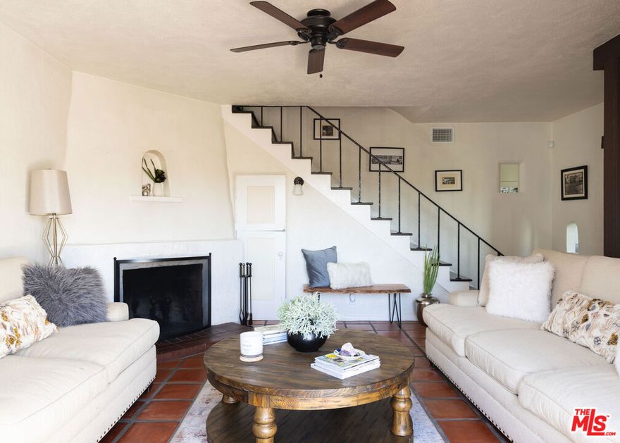 Immersed in the fabric of Los Angeles, this hillside Mediterranean jewel offers numerous lounging decks and rooftop terraces with views of iconic landmarks. This storied duplex comprises both 2039 and 2041 Glencoe Way and was previously owned by Theo Wilson, a trailblazing journalist for the Los Angeles Times and New York Times. Experience a dreamy, enchanting lifestyle that only a home of this original character can provide, with rich period aesthetic details preserved inside and out. Vivid color complements moody hues to inspire deep thought and creativity. At 2041, enjoy authentic Spanish terra cotta tile floors, stucco fireplace, and built-ins in the delightful living room with French doors that open to the front patio. The kitchen is warm and inviting with a subway tile backsplash, aegean blue cabinetry, stainless-steel appliances, and bar ledge. The formal dining room, with its rich wood floors, also has French doors to the outside. A wrought-iron staircase leads to the primary bedroom with picture windows framing sweeping views of the city, and secondary bedrooms and bathrooms have built-ins and period details. One of the bedrooms has its own private entrance, offering added flexibility and privacy. There is also an office/gaming room with vaulted ceilings with exposed beams surrounded by striking vistas of treetops and hillsides. The living room of 2039 features an original 1926 brick fireplace, entertainer's bar, charming bookcase, and lofty ceiling with exposed beams, with direct access to a spacious patio perfect for outdoor gatherings. The eat-in kitchen has been extensively and beautifully updated with copper hardware, open shelving, bright subway tile backsplash, an abundance of cabinetry, and top-of-the-line appliances. The primary bedroom has a large skylight, French doors opening to a rooftop lounging deck, an adjacent sitting alcove with picture window, and en-suite bathroom. The secondary bedroom, currently used as an office, offers direct access to the outdoors and features its own en-suite bath. Relax, entertain, and dine al-fresco from multiple tiered patios, screened for privacy from the street, including a trellis-covered outdoor dining room with views of the hills and city. Both addresses include covered parking and an in-unit laundry. Live in one and rent out the other for a steady flow of passive income. The Hollywood Bowl is also close by, with no need for ride-share or transportation. 2039 is Luxury Exempt and therefore not subject to the limitations of rent control. Within the last five years, many updates have been made throughout; both addresses have newer water heaters, water filtration systems, and HVAC. New doors and windows come with a transferrable 10-year warranty. 2041's upgrades include a newly installed EV charging station and kitchen appliances (three years), and 2039's kitchen has updated flooring, cabinetry, lighting, and appliances (two years). Welcome!