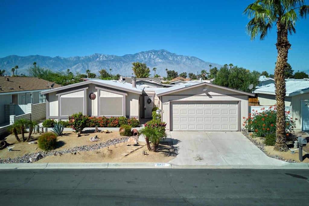 Beautifully Updated Home with Mountain Views in Tri Palm Estates & Country Club!Welcome to this stunning 2-bedroom, 2-bath home nestled on a quiet cul-de-sac in the sought-after Tri Palm Estates & Country Club, an active 55+ golf community where YOU OWN THE LAND. This newer home offers vaulted ceilings, an open-concept floor plan, and stylish upgrades throughout. Enjoy a modern kitchen with granite countertops, gas cooktop, double ovens, and updated fixtures. The cozy living room features a fireplace and large windows framing lovely mountain views. The spacious owner's suite includes a custom roll-in tile shower and updated bathroom. Both bathrooms and flooring have been thoughtfully remodeled, and built-ins add character and functionality.Step outside to your private oasis--an enormous covered patio perfect for entertaining, complete with swag lighting, patio furniture, and a large private hot tub.Best of all, THIS HOME IS ON A MERNENT FOUNDATION WITH FORM 433A, making it eligible for easy financing.Community Perks:Tri Palm Estates offers unlimited fee-free golf on both an 18-hole and 9-hole par-3 course, plus access to swimming pools, spas, tennis, pickleball, shuffleboard, and more. The clubhouse features a restaurant, bar, banquet room, billiards, and free Wi-Fi.Located just minutes from Costco, Home Depot, Agua Caliente Casino, Eisenhower Medical Center, and Acrisure Arena, with easy access to I-10 for quick trips to Rancho Mirage, Palm Desert, and downtown Palm Springs.Don't miss this opportunity for affordable luxury in one of the desert's best active adult communities!