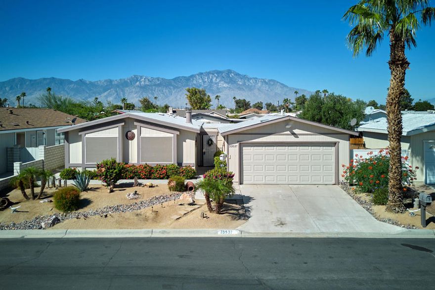 Beautifully Updated Home with Mountain Views in Tri Palm Estates & Country Club!Welcome to this stunning 2-bedroom, 2-bath home nestled on a quiet cul-de-sac in the sought-after Tri Palm Estates & Country Club, an active 55+ golf community where YOU OWN THE LAND. This newer home offers vaulted ceilings, an open-concept floor plan, and stylish upgrades throughout.  Enjoy a modern kitchen with granite countertops, gas cooktop, double ovens, and updated fixtures. The cozy living room features a fireplace and large windows framing lovely mountain views. The spacious owner's suite includes a custom roll-in tile shower and updated bathroom. Both bathrooms and flooring have been thoughtfully remodeled, and built-ins add character and functionality.Step outside to your private oasis--an enormous covered patio perfect for entertaining, complete with swag lighting, patio furniture, and a large private hot tub.Best of all, THIS HOME IS ON A MERNENT FOUNDATION WITH FORM 433A, making it eligible for easy financing.Community Perks:Tri Palm Estates offers unlimited fee-free golf on both an 18-hole and 9-hole par-3 course, plus access to swimming pools, spas, tennis, pickleball, shuffleboard, and more. The clubhouse features a restaurant, bar, banquet room, billiards, and free Wi-Fi.Located just minutes from Costco, Home Depot, Agua Caliente Casino, Eisenhower Medical Center, and Acrisure Arena, with easy access to I-10 for quick trips to Rancho Mirage, Palm Desert, and downtown Palm Springs.Don't miss this opportunity for affordable luxury in one of the desert's best active adult communities!