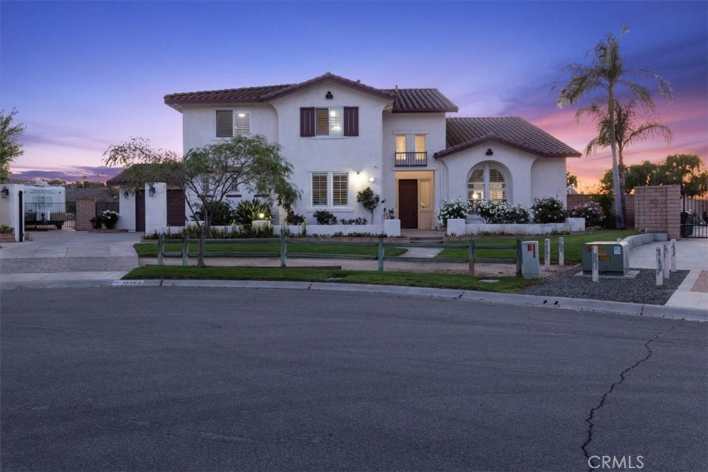Stunning Norco Hills Estate with Pool, Panoramic Views!
Welcome to your dream home in the highly sought-after Norco Hills community! Situated on an expansive nearly 1-acre lot, this gorgeous estate pool home is the perfect blend of luxury, comfort, and functionality. Step inside to find new porcelain tile flooring throughout the first floor, setting the stage for elegant living. The flexible downstairs room can serve as a home office, guest suite, media room, or fifth bedroom, complete with its own private bath. Enjoy hosting in the formal living room with soaring vaulted ceilings and the formal dining room, featuring custom-built-ins and a chic white wine rack. The upgraded kitchen is a chef’s delight with a large island, ample cabinetry, and a spacious pantry, seamlessly opening to a cozy family room with a custom fireplace and built-ins. Head upstairs via the striking wrought iron staircase to find a versatile loft, secondary bedrooms, and your private primary suite retreat—boasting a fireplace, sitting area, and a private balcony overlooking the breathtaking backyard. The fully remodeled en-suite bathroom offers a luxurious spa-like experience. Step outside and be transported to a resort-style paradise: a saltwater, heated pool, waterfall feature, fire pit, built-in BBQ, and a children’s play area—all beautifully landscaped with panoramic views as your backdrop, perfect for entertaining year-round. Additional highlights include: 4-car garage with epoxy floors, RV access, plenty of Space for an ADU, and horse facilities. Don’t miss this rare opportunity to own one of Norco Hills’ finest homes.