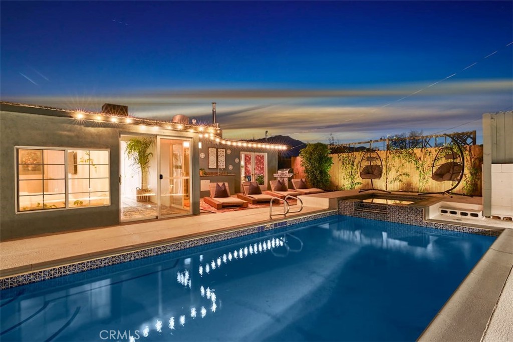 Turnkey, fully furnished, and already cash-flowing—this bold 3-bed, 2.5-bath Bohemian Maximalist retreat is a city-permitted short-term rental (VR22-0134) grossing over $78K in 2024. Whether you're seeking a stylish lifestyle asset or a high-performing investment, this Desert Hot Springs property delivers strong returns and standout appeal. Located just 15 minutes from downtown Palm Springs, the home features a private heated pool and spa, oversized patio with market lighting, built-in outdoor cooking area, multiple lounging zones, and yard games. Inside, the fully remodeled kitchen boasts granite counters and modern stainless appliances, while the bathrooms feature walk-in tiled showers, modern vanities, under-cabinet lighting, and thoughtful designer finishes throughout. Bold wallpaper, curated decor, and high-quality furnishings bring personality and comfort to every space—everything seen is included in the sale. Multiple 4K smart TVs, upgraded mattresses, an indoor air hockey table, and turnkey operational touches make this a plug-and-play short-term rental ready for immediate income. Home is currently set up to host larger groups and has confirmed guest bookings through late November, offering buyers built-in revenue from Day 1. Future bookings can be canceled to allow immediate occupancy for primary buyers. Ideal for a second home, 1031 exchange, or fully managed vacation rental portfolio. Priced below many nearby new construction homes (none of which include pools), this unique offering delivers instant ROI, long-term upside, and one-of-a-kind charm. Note: Fireplace in primary bedroom has been removed for safety.