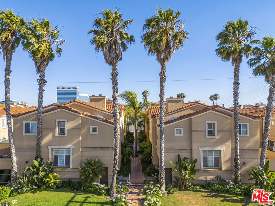 Welcome to this stunning Contemporary Mediterranean style home in the highly desirable city of El Segundo! This bright and freshly painted end-unit townhouse features 3 bedrooms and 2.5 bathrooms, offering the perfect blend of comfort, convenience, and modern style. As you walk down the beautifully manicured path to the front door, you'll be greeted by lush greenery that sets a serene tone. Step inside to find a spacious family room or office, complete with high ceilings, abundant windows, and a cozy fireplace a perfect space to unwind or work from home. Just a few steps up, the open-concept living, dining, and kitchen area awaits. The kitchen includes a charming breakfast nook and a convenient half bath. The living area boasts sliding glass doors that open to a large private patio ideal for morning coffee, entertaining guests, or simply relaxing outdoors. The third floor, newly carpeted for comfort, features three bedrooms, a full hallway bathroom, and a convenient laundry area. The primary suite includes its own fireplace, and an ensuite bathroom with dual sinks and a granite countertop, plus additional built-in closets. Additional highlights include nest thermostat, custom blinds throughout the home, two side-by-side parking spaces in a secure gated garage, and close proximity to top-rated schools, parks, shops, dining, and the beach. Enjoy easy access to major freeways and LAX, making commuting a breeze.Move-in ready and full of charm, this home combines contemporary living with an unbeatable El Segundo location. Don't miss the opportunity to make it yours!