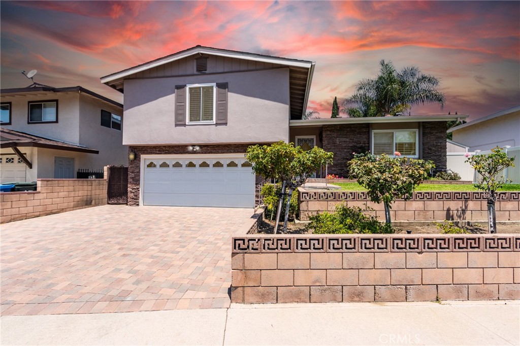 This charming single family home is quietly nestled in a cul-de-sac in desirable Rowland Heights. Featuring 4 bedrooms and 2.5 bathrooms, the layout offers flexibility for multigenerational living, guests, or a growing family. The main level welcomes you with a sunlit living room and cozy fireplace, seamlessly connected to a spacious kitchen with granite countertops, abundant cabinetry, and easy-care tile flooring.
Downstairs, a private bedroom with a nearby half bath is ideal for visitors or a home office. Upstairs, three additional bedrooms—including a generously sized primary suite—provide bright and comfortable living spaces.
Step outside into a tranquil backyard oasis complete with a serene pond, mature fruit trees, and two detached sheds—one with air conditioning—offering additional space for storage, a studio, or workspace. The attached garage includes custom shelving for added convenience.
Notable upgrades include new flooring, new window blinds, dual-pane windows, updated HVAC and attic insulation for energy efficiency. Located near top-rated schools, the public library, shopping centers, and with quick access to the 60 and 57 freeways.