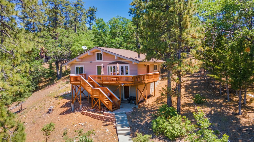 Discover the charm of Fawnskin, located on the serene North Shore of Big Bear Lake. This inviting home features an estimated 142 square feet of additional loft space, accommodating three twin and one king size bed, perfect for guests or family. Ample storage is available in the spacious basement area. The front deck offers breathtaking views of Big Bear Lake and the north slope of Mt. San Gorgonio, a sight you'll never tire of. Inside, an oversized wood stove, complemented by a gas furnace, ensures warmth and comfort during the winter months. This property has been lightly used, serving as a vacation home since at least 1996, preserving its excellent condition. Lot and dwelling square footage, and other declarations are not guaranteed and should be confirmed by the Buyers and their Agent.