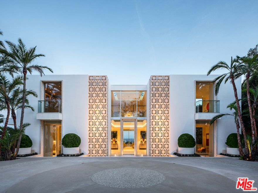 "The Promontory" Ultimate view estate sited on an approx. 3/4 acre point lot. A masterful creation by renowned Architectural designer Tim Morrison, this World-Class modern references elements of Hollywood Regency and the grand estates of Palm Beach. Meticulously crafted interior of approximately 11,000sqft showcasing unparalleled quality. Two-story skylight foyer, grand dining room, formal living room, and mid-century bar all flow effortlessly for entertaining. Spectacular master with explosive jetliner views, sitting room and dual baths. Additional features include a sumptuous screening room, 4 bedrooms, gym, and gourmet kitchen. One of the few drive-on view estates, behind gates with a vast motor court and 4 car garage. The rear grounds offer spectacular formal gardens and dramatic floating zero edge pool. Destined to be a legend.