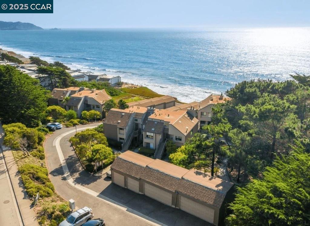 Discover your slice of peaceful coastal living within the serene Pacific View Villas, a boutique 13-unit condominium community. This inviting two bedroom, two bathroom home offers a comfortable and stylish retreat. Enter into an open-concept livable space, featuring beautiful bamboo flooring that flows seamlessly throughout. The recently updated kitchen boasts sleek quartz countertops, providing a modern and functional space for culinary enjoyment. Sliding glass doors open to a semi wrap-around patio with an ocean view—an ideal spot to enjoy morning coffee or evening relaxation. Both bedrooms are designed for restful comfort, with the primary suite offering a peaceful escape. Updated bathrooms enhance the home's contemporary appeal. Enjoy the convenience of in-unit laundry and a one-car garage with ample storage. Pacific View Villas fosters a genuine sense of community, a true retreat within the vibrant tapestry of coastal living. Embrace the tranquility of beachside living, with easy access to major routes for effortless commutes to San Francisco and Silicon Valley, making this the ideal balance of peaceful retreat and connected living. Welcome to your tranquil coastal dream.