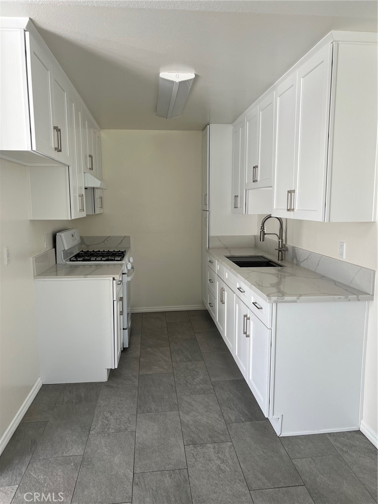 Ready for immediate lease! Totally redone 1 bedroom and 1 bath in the heart of the west valley. Newly renovated from A to Z! Brand new kitchen with shaker cabinets, quartz counters, and stainless-steel appliances. Beautiful updated bath with stand up shower and updated quartz vanity. Some of the other upgrades include central heat and air, recess lighting, laminate floors, new doors, and much more. Nice sized balcony off of the living room. The complex is gated as well. Comes with one car assigned parking. Shared laundry room on site. Adjacent to Warner Center and close to shopping centers, restaurants, and freeways.