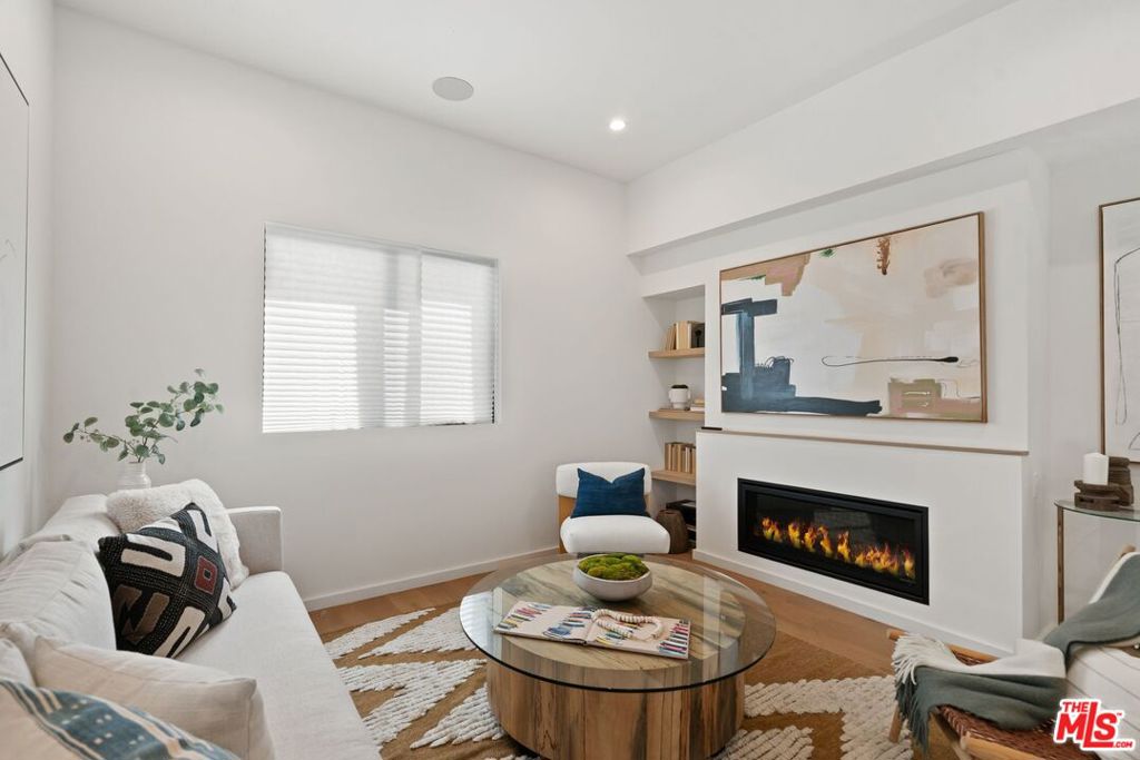Embrace striking modern architecture and refined coastal living in this newly built 4-bedroom, 4.5-bath single-family home in the heart of Mar Vista, just minutes from Venice Beach and Abbot Kinney. Thoughtfully designed with natural textures and clean lines, the open-concept layout features a custom chef's kitchen, warm fireplace, and seamless indoor-outdoor flow. The private primary suite occupies its own level with a spa-inspired bath, walk-in closet, and sunlit terrace, while two additional ensuite bedrooms offer comfort and privacy. A rooftop deck with sweeping city and mountain views and a private 2-car garage with direct entry complete this contemporary retreat. With one of the most competitive price-per-square-foot offerings in the neighborhood, this home delivers unmatched value in one of Los Angeles's most sought-after locations.