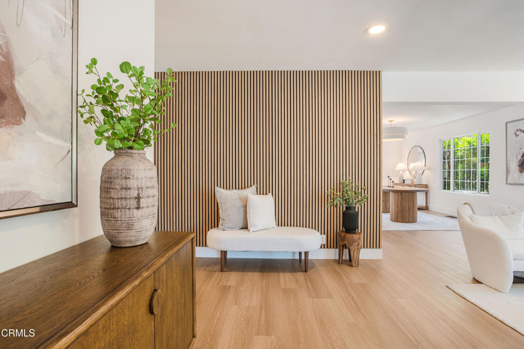 Located in the highly desirable Toluca Lake neighborhood, this extraordinary four-bedroom, four-bath residence of nearly 3,500 square feet has been fully reimagined into a turn-key sanctuary where no expense was spared. Originally built in 1947, the home retains its timeless character with vaulted ceilings, exposed wood beams, expansive walls of glass, and tongue-and-groove detailing, now elevated by thoughtful renovations and luxury upgrades.Recent improvements include a brand-new roof, a double electric security gate for the driveway, a newly gated trash enclosure, and completely redesigned landscaping in both the front and back yards. Modern comforts abound with a new tankless water heater, a water circulation system, and a state-of-the-art full home security system. Inside, custom shelving in the pantry and garage, a newly designed walk-in closet, and bespoke draperies and shades add both elegance and functionality.The home's light-filled interiors feature skylights and French doors that open to private patios and gardens, creating seamless indoor-outdoor living. The primary suite serves as a serene retreat with its own sitting area and balcony overlooking the grounds. Upstairs are two additional bedrooms and a versatile den, ideal for a home office or media room, while a guest-ready ensuite on the main level provides convenience and flexibility.Set on a generous 8,200+ square foot lot, this residence balances refined interiors with beautifully landscaped outdoor spaces. Its location places it moments from top restaurants, boutique shopping, cafes, and major freeway access, offering the perfect blend of luxury and everyday convenience.More than a home, this is the transformation of a classic Toluca Lake property into a sophisticated, move-in ready haven. Every detail has been carefully considered, creating a rare opportunity to own a timeless residence that combines architectural pedigree with modern enhancements.