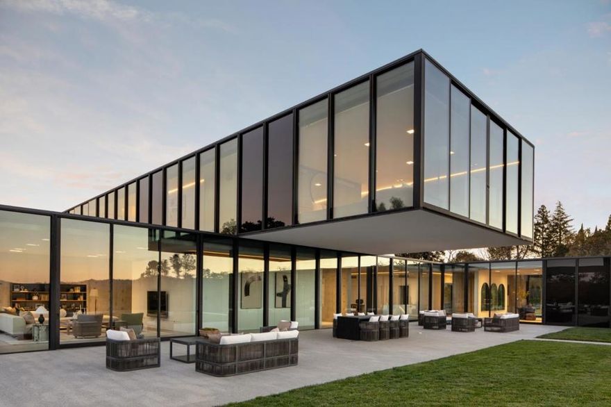 This engineering and architectural masterpiece is a one-of-a-kind residence made from the highest level of architectural formed concrete, glass, and steel. Built in 2017, the home comprises two L shaped forms that balance on top of one another, creating courts and overhangs that define the indoor and outdoor spaces with bridges and two floating cantilevers, each spanning 23 feet. Designed as much for the terrain as for privacy, the walls facing the street are primarily solid with strategically placed glass, allowing natural light to brighten the space. On the sides away from the street, the walls are made entirely of glass, offering maximum enjoyment of the far-reaching views out to the San Francisco skyline. There are 16,000 total square feet, with a three-level main residence plus two separate buildings, each with a full kitchen, with flexibility for guests, office, and/or poolside entertaining needs. Behind the scenes, everything needed for comfort and convenience is found with wiring for home automation, solar panels for electricity, and multiple car charging stations. Added amenities include such luxuries as a 7-hole putting green with bunker, golf simulation screen, theater, and a design for elevator, if desired.