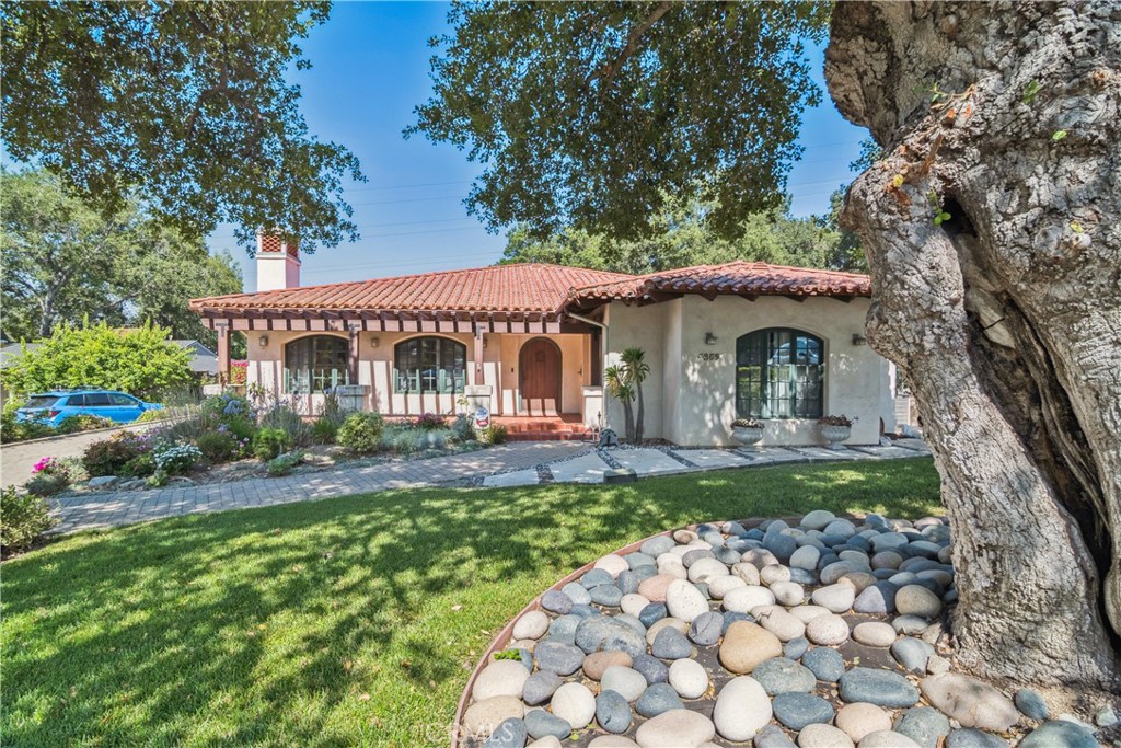 True California indoor/outdoor living experience in the heart of the desirable Descanso Gardens neighborhood. This exquisite 5 bedroom, 4 bathroom Spanish-style home is nestled on a sprawling, nearly 19,000 square foot lot. At the rear of the yard, you'll find a fully private guest house with a bedroom, bathroom (ADA compliant), living area, full kitchen, laundry, and direct access to a private garage. Upon entering through the custom arched wooden door, you're greeted by a bright and inviting living room with a fireplace that seamlessly flows into the elegant formal dining room. The spacious remodeled chef's kitchen, with quartz countertops and a comfortable breakfast nook, boasts double sliding doors that open to the outdoor patio and pool. The open family room features arched shelving and hardwood floors. A hallway off the family room leads to two bedrooms, including the master suite with a walk-in closet and a remodeled bathroom offering dual sinks and a walk-in shower and stand alone tub, as well as an additional 3/4 bathroom. Another hallway connects to two more generous bedrooms and a full bathroom. A mudroom and laundry area round out the main home. The property includes a sparkling pool, surrounding patio, and a lush grassy yard with mature trees. This beautiful home is conveniently located near hiking trails and top rated, award-winning La Canada schools.