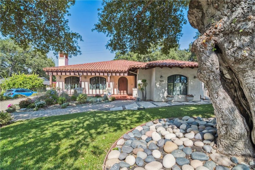 True California indoor/outdoor living experience in the heart of the desirable Descanso Gardens neighborhood. This exquisite 5 bedroom, 4 bathroom Spanish-style home is nestled on a sprawling, nearly 19,000 square foot lot. At the rear of the yard, you'll find a fully private guest house with a bedroom, bathroom (ADA compliant), living area, full kitchen, laundry, and direct access to a private garage. Upon entering through the custom arched wooden door, you're greeted by a bright and inviting living room with a fireplace that seamlessly flows into the elegant formal dining room. The spacious remodeled chef's kitchen, with quartz countertops and a comfortable breakfast nook, boasts double sliding doors that open to the outdoor patio and pool. The open family room features arched shelving and hardwood floors. A hallway off the family room leads to two bedrooms, including the master suite with a walk-in closet and a remodeled bathroom offering dual sinks and a walk-in shower and stand alone tub, as well as an additional 3/4 bathroom. Another hallway connects to two more generous bedrooms and a full bathroom. A mudroom and laundry area round out the main home. The property includes a sparkling pool, surrounding patio, and a lush grassy yard with mature trees. This beautiful home is conveniently located near hiking trails and top rated, award-winning La Canada schools.