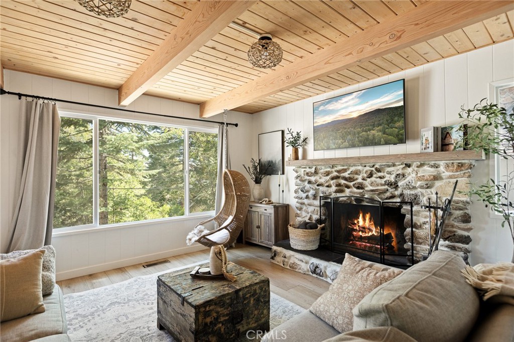 SO COZY!!! SO FRESH & NEW!!! And Just a Block From the LAKE & the VILLAGE!!! WOW!!! Run Away to the Mountains to this Adorable FURNISHED Cabin with Super Comfy Living Room & Oversized Kitchen with the Cutest Upgrades!! All Wide Open, Perfect for Entertaining!! There's Even a Peek of the Lake! Bedroom on Main Level is Currently Being Used as a Den, Extending off of the Living Room, but Can Easily Be Converted Back. The BACKYARD is to Die For!!!! Extra Large and Very Useable!! Perfect for the Kids and Dogs to Play! Full Bath on Main Level for Guests. Upstairs are Two More Bedrooms with Lots of Natural Light & Dreamy Views of the Towering Pines & Cedars that We All Love! Excellent Parking for Multiple Cars and So Easy to Just Stroll on Over to the Village for a Yummy Meal with Lake Views or a Quick Dip in the Lake!! THIS IS THE LIFE!! This Home has Also Been a Successful Short Term Rental too!! (Income Available Upon Request). Come & See Before It's Gone, Gone, Gone! This is a REALLY GOOD ONE!! (House is on the CORNER OF MITTRY & SNOWFLOWER)