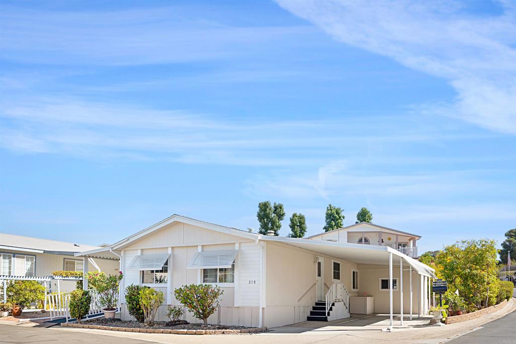 Comfortable three bedroom home on corner lot in premier senior park. Home has been lovingly cared for and has an open floorplan with large living room, dining room and spacious kitchen. The three bedrooms are all generously sized and there is plenty of storage. Additionally there is a laundry room, wheelchair ramp and covered patio to enjoy your morning coffee! The fully accessible yard offers room for container gardening along with a shed for your tools. The Meadows is HOA style ownership which means there is no space rent, only the low HOA fee of $319 per mo. The fee includes trash, water, limited cable TV and all amenities. This active community has a year round heated salt water pool & spa, pickleball/tennis courts, putting green, clubhouse, and much more! Located only 15 minutes from medical, shopping and entertainment and Lake Jennings is just five minutes away.