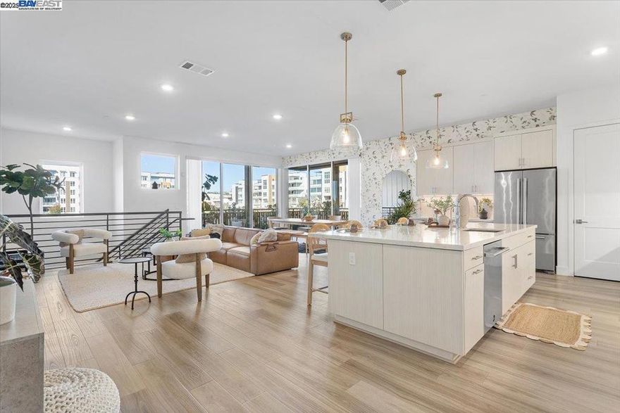 DON'T MISS THIS. A two-story luxury condo that elevates modern living in Fremont. This property features a bright open-concept layout with two entry points, including a private street-level entrance and a secured attached two-car garage with EV charging capabilities, blending high-end design with everyday convenience.  The ground floor includes a grand foyer and a private ensuite, offering comfort and privacy on its own level. Upstairs, an impressive open-concept kitchen, living, and dining area serves as the heart of the home, with expansive sliding doors that open to a private wraparound balcony for seamless indoor-outdoor living. A bright hallway leads to two additional bedrooms and two full bathrooms, including a spacious primary ensuite with a walk-in closet and dual vanity.  Residents of this highly desirable community enjoy access to resort-style amenities including a clubhouse, fitness center, pool, spa, and beautifully maintained outdoor spaces. Situated near top-rated schools, major commuting routes, BART, and Fremont’s vibrant shopping and dining corridors, this home offers convenience without sacrificing luxury. This is a rare opportunity to own a home that offers luxury, space, and modern functionality.