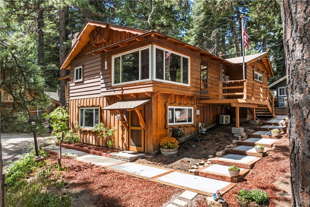 This mountain home blends vintage character with modern comforts in peaceful Running Springs. Inside you will find new engineered hardwood floors throughout and unique wood details that showcase the home’s timeless charm. Unwind in comfort, thanks to upgraded amenities like a Generac generator, tankless water heater, water softener, and a mini-split heating and cooling system for year-round ease. Nature lovers will adore the beautiful landscaping, complete with multiple outdoor spaces to explore and enjoy. Thoughtful fencing surrounds the property, plus a dedicated dog run and convenient yard access make this home a pet haven. Downstairs, gather around the impressive oversized stone fireplace - an ideal spot for a cozy family room or bedroom retreat - adjacent to a bath with a jetted tub. Upstairs features two welcoming bedrooms and a bath with classic beadboard finishes. The spacious kitchen with all new appliances and a spacious island opens to a sunny patio, perfect for grilling and outdoor entertaining. Storage is abundant, with a garage, carport, detached shed, and versatile nook, plus a large build-up area for all your gear and treasures. Set on a tranquil street, this property offers a unique blend of privacy, history, and practicality. Discover classic 1950’s craftsmanship, generous parking, and endless places to relax.