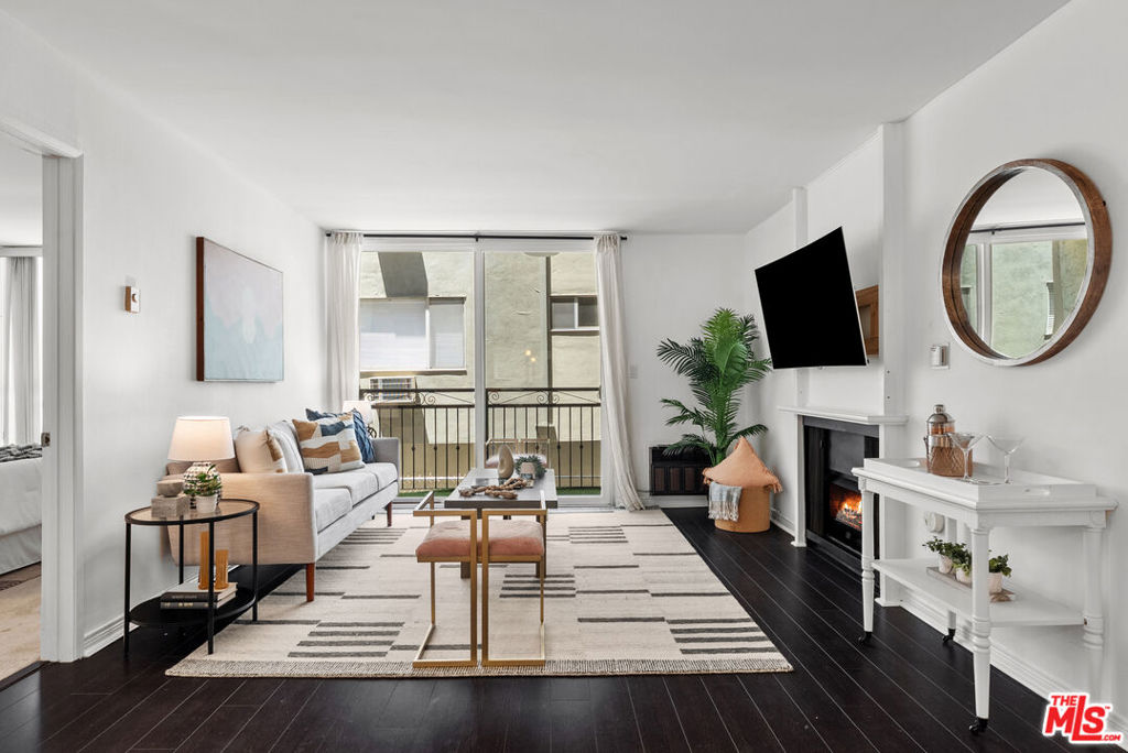 Stylish and spacious, this beautifully appointed two-bedroom, two-bathroom condo offers an ideal floor plan in one of Westwood's most sought-after locations. Enter through a serene courtyard framed by palm trees and lush landscaping, and step into a freshly painted unit featuring rich wood floors in the living area and a private balcony. The open-concept kitchen includes bar seating, ample cabinetry, and a dishwasher, and flows seamlessly into the great room, complete with a cozy fireplace, perfect for both relaxing and entertaining. Each bedroom enjoys the comfort and privacy of an en-suite bathroom, creating two inviting primary suites, one of which features the same wood flooring as the living area. Located in a secure, gated building surrounded by charming single-family homes on a prime stretch of Veteran Avenue. Community amenities include a pool, exercise room, community laundry room on each floor, extra garage storage, and more. Don't miss this fantastic opportunity to own in the heart of Westwood!