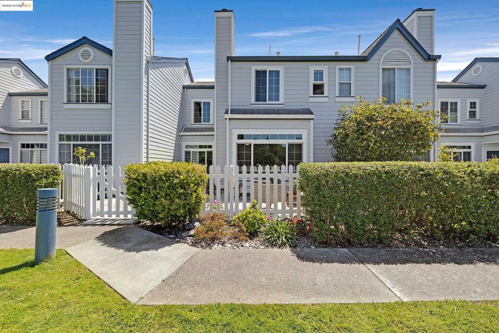 Come live at "The Beach" in the gorgeous Marina Bay! Spacious layout with high ceilings, a light-filled family room & dining area with a woodburning fireplace and beautiful hardwood floors. Updated windows and updated kitchen with lots of storage and a half bath with stackable washer/dryer. Upstairs you will find 2 spacious bedrooms w/ en-suite bathrooms. This home also features security gated access to your deeded 2-car parking, with EV charger, and bonus hidden storage. Enjoy your morning coffee or evening sunsets from your beautifully landscaped front yard with an adorable white picket fence and gated community walking path. Amenities galore all within minutes away! Enjoy the fabulous Sunday Farmer’s Market, Bay Trail, Beach, Sailing school, Marina, Richmond Ferry, plus great shops, restaurants and breweries and more!