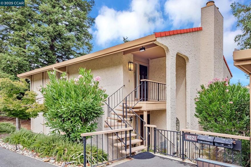 You’ll love the two spacious balconies offering fantastic golf course views! Enjoy serene vistas of rolling hills framed by both deciduous and evergreen trees. This desirable Villa Madrid model is a duplex that lives like a penthouse, with no shared walls for exceptional privacy.  The elegant living room features a beautiful gas fireplace and classic wainscoting, creating a warm and inviting atmosphere. The kitchen offers abundant counter space and a large pantry, while the breakfast room is perfect for casual dining. The primary suite includes a secluded private balcony—your own peaceful retreat.  A covered, oversized carport with a storage room is conveniently located at the bottom of the stairs. The Mutual (HOA) also offers its own club room for residents to enjoy.