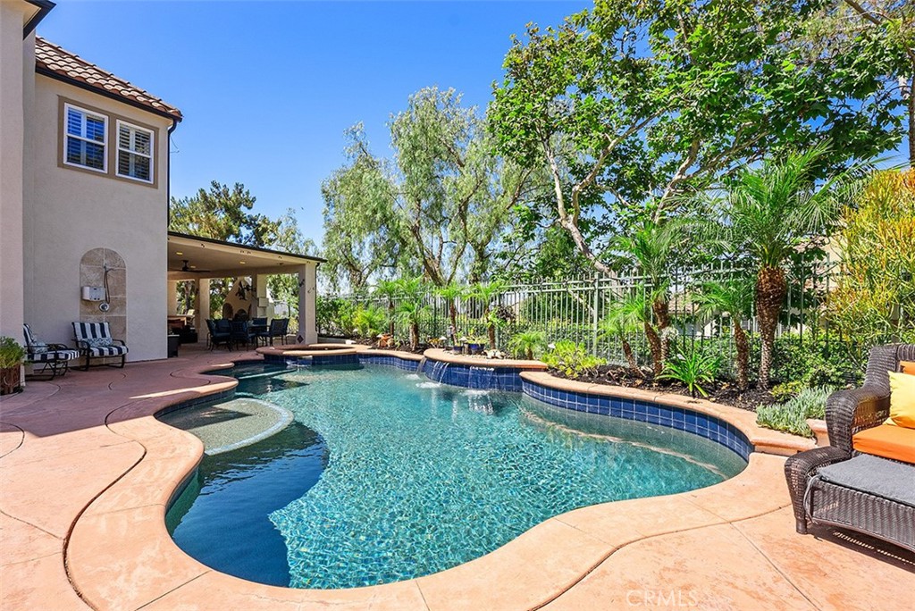 Discover this exceptional Dove Canyon residence, ideally situated on a private end-of-Cul-de-Sac, Generously Sized Lot with Owned Solar plus stunning views. The resort-style backyard is an entertainer's dream, featuring a custom outdoor fireplace, built-in BBQ with an oversized bar, PebbleTec salt water pool and spa, sports court, and extensive hardscaping. Step inside to a welcoming living room featuring a fireplace. Adjacent to the living room you will find a dining room and a custom dry bar. The kitchen boasts newer stainless steel appliances, newer cabinets, granite countertops, a breakfast nook, and ample cabinet space. An oversized family room seamlessly connects to the outdoor entertainment areas. The downstairs is complete with a bedroom with ensuite bathroom, a laundry room, and a three car garage. Upstairs you will find a spacious bonus room and four bedrooms with custom closet organizers. The primary bedroom includes custom built-in closets and spectacular sunset views. The primary bathroom includes a tub, separate walk-in shower, and dual-sinks. Enjoy the unique feature of having an end-of-cul-de-sac lot with endless potential. This home also features owned solar, providing energy efficiency and cost savings. Located within a prestigious 24-hour guard-gated community, and as a resident of Dove Canyon, you’ll enjoy No Mello Roos, access to a Jr. Olympic pool, tennis courts, pickleball court, sport court, playground, and scenic trails with access to hiking, biking and horse trails. You will also have the option to join Dove Canyon Golf Club, a Jack Nicklaus Signature design with dining, wine room, gym and more.