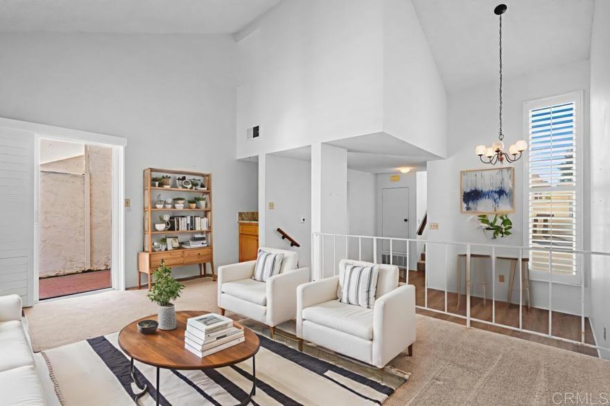 Centrally located and right on the border of El Cajon and Santee is this great split level townhome in the Lakeridge Park community. This townhome offers its own private use yard with access to a common greenbelt area as well as a 1 car garage and covered dedicated parking. The main level features an elevated living room with vaulted ceilings open to the dining room, a mini wet bar, and a galley kitchen with oak cabinets and granite countertops. The mid level is solely the primary suite also with vaulted ceilings, ensuite bathroom, and a balcony. The top level is the non primary bedroom with a balcony as well and a peek-a-boo opening down to the living room. Laundry can be found behind a bifold closet door in the kitchen. This home is outfitted with shutters throughout and has central heating and air. Affordable and ready for you to move in and make it your own. Come see this listing today! (Some photos have been virtually staged)