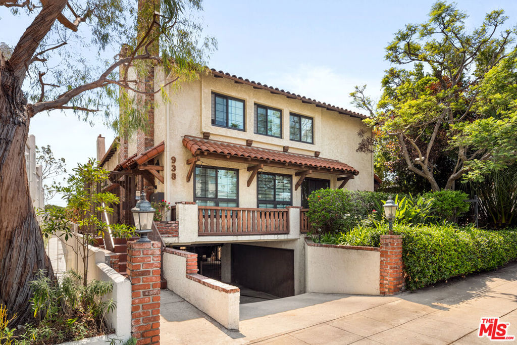 In a prime Santa Monica setting, this updated two-bedroom, two-and-a-half-bath townhouse spans two levels of thoughtfully designed living. Hardwood floors ground the expansive main level, where soaring ceilings create volume and light in a generous living area anchored by a sleek central fireplace. The adjoining kitchen is finished with granite counters and a full suite of stainless-steel appliances, including a refrigerator, range, dishwasher, and microwave. A bar-top counter and casual breakfast nook extend seamlessly to a petite outdoor patio, offering a natural flow for both daily routines and relaxed gatherings. A full-sized washer and dryer add convenience on the main floor. Upstairs, both bedrooms feature walk-in closets and window shutters, while the spacious primary retreat impresses with vaulted ceilings and an oversized en-suite bath complete with a walk-in shower. Two parking spaces accompany the residence, enhancing everyday ease. Just moments from the beach, Downtown Santa Monica, Douglas Park, Lincoln Middle School, and a variety of neighborhood amenities, this townhouse offers a balanced blend of comfort, function, and location.