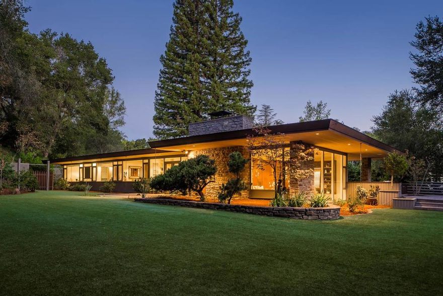 Designed by John "Jack" Kruse, this unique mid-century modern home was built to uniquely high specifications. Nestled on nearly 2 acres of flat beautiful land, this home offers much privacy and a huge backyard. There are many features such as recessed lighting, built-in speakers, polished concrete floors and ample storage. The formal living room features floor to ceiling glass windows and the dining room and family room have large sliding glass doors that open to the BBQ area, a large patio and deck areas for indoor/outdoor living. The chefs kitchen features a center island, Wolf 6 burner gas stove, oven, espresso machine, and Liebherr refrigerator. The primary bedroom features a built-in leather headboard, built-in desk, closet organizers and bathroom oasis with dual vanity and soaking tub. In addition to the main home, there is a detached studio cottage with a full bath and kitchenette. Come experience the tranquility of this amazing home and a one of a kind design!