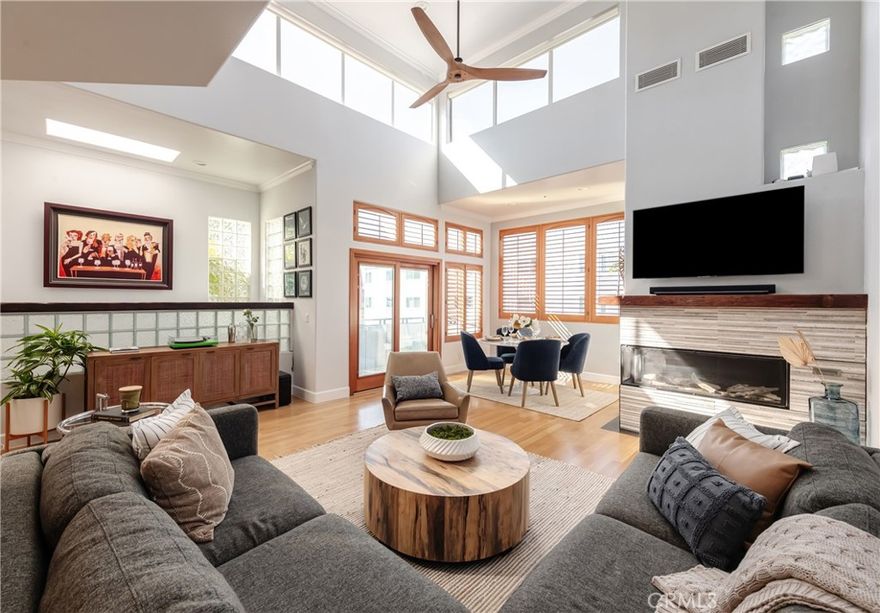 Just moments from the sand and downtown’s boutiques and restaurants, this custom contemporary townhome combines dramatic architecture with a relaxed, beach-town vibe. Soaring 18-foot ceilings create volume and openness, while oversized windows and Pella doors bring in natural light and frame glimpses of ocean views. From the main living space, step onto the west-facing deck — the perfect spot to savor morning coffee, golden-hour cocktails, or the nightly sunset show.
One of only three residences with direct garage access, the home balances style and function with light oak floors, a sleek new fireplace, and a thoughtful, open layout. The updated kitchen features Viking appliances, custom cabinetry, and granite counters, designed to flow easily into the dining and living areas for effortless entertaining.
The primary suite is a retreat unto itself, with a sunny enclosed patio, a cozy fireplace, dual walk-in closets, and a spa-inspired bath complete with sauna, heated stone floors, and towel warmer. Two additional bedrooms and plenty of built-in storage make the home as practical as it is polished.
Plantation shutters, recessed lighting, and refined finishes add to the tailored feel inside, while the location keeps you close to everything that makes Manhattan Beach special.
A rare opportunity where design, comfort, and coastal lifestyle meet — just blocks from the heart of downtown, where every day feels like vacation.