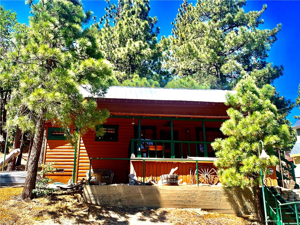 Step back in time with this charming vintage cabin on a large corner. This cabin is a must see in the quaint town of Green Valley Lake that offers that small town vibe. This rustic little gem has one bedroom and one bathroom with a loft for additional sleeping. The Livingroom has a beautiful brick fireplace for those cold winter days. Open beam ceilings and T&G throughout. Fun retro kitchen that is open and bright with plenty of storage space. Nice covered deck for relaxing or BBQing. Play horse shoes with family and friends on those warm summer days. Close to the lake, town and marina for fishing, boating and swimming. Plenty of hiking trails to enjoy. Come and see what this great little town has to offer you and make memories for a life time.