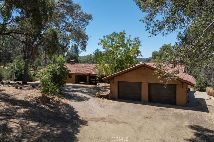Sprawling one-of-a-kind home on large acreage with the west fork of the Chowchilla River meandering through the property - less than 15 minutes from the town of Mariposa and an hour from Yosemite National Park! Situated on 14.77 private wooded acres, this adobe home is an entertainer's dream, with an overabundance of character and space. With a total of 3361 square feet, this home features a grand step-down living space, large formal dining room, and a vast kitchen area with a built-in fireplace and barbecue grill. These spaces are absolutely perfect for hosting large events or family gatherings! The home features 3 bedrooms and 2 bathrooms, with a sizable garage designed for storage and functionality. The property also features a detached barn with a functional shop space down below for the car enthusiast, and an upstairs area that can function as a place for recreation or guest quarters. The Chowchilla River is accessible via a roadway beginning at the home, so it is walkable! The structures could use a bit of TLC, but with the right vision, this place could be a fantastic home for those looking for some elbow room and peace amongst the Sierras.
