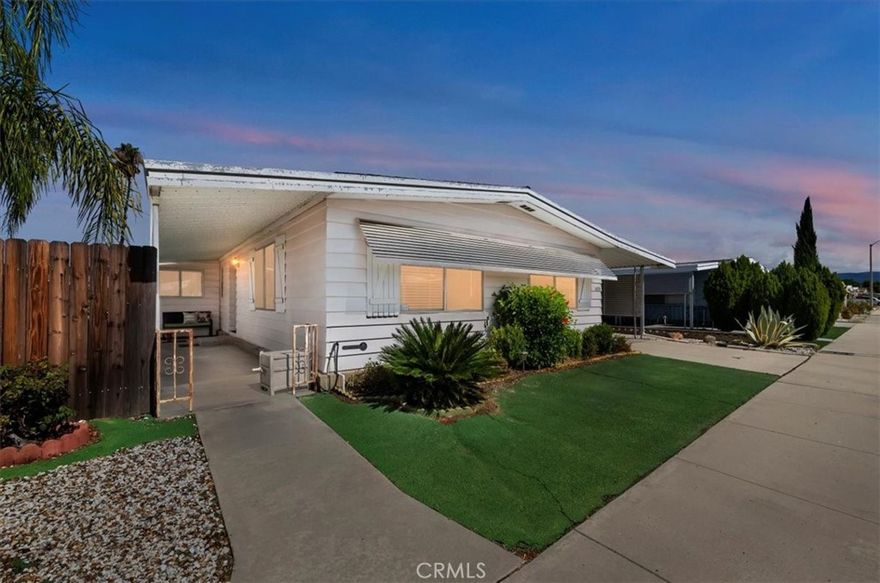 Welcome home to Sierra Dawn Estates, a vibrant 55+ community where you own the land—no space rent! This beautifully maintained two-bedroom, two-bath manufactured home offers a light, bright, and open floor plan designed for comfort and functionality.
Inside, enjoy dual primary suites, each oversized with two spacious closets, private baths, and flexible space ideal for guests, in-laws, or a caretaker. The inviting living room features a custom feature wall with a mounted TV that stays, while the dining area showcases a charming built-in china cabinet. The kitchen is airy and cheerful, boasting stainless steel appliances, laminate countertops, two pantries, a large farmhouse sink, and plenty of cabinet space for storage.
Additional highlights include a new AC unit, furnace, water heater, and garbage disposal, ensuring worry-free living. The interior laundry room offers extra storage and a convenient folding area, with even more storage available throughout the home. Several extra boxes of flooring are included for future projects or repairs.
Outside, enjoy the low-maintenance yard enclosed by a tall privacy fence—perfect for gardening, relaxing, or entertaining. The large attached workshop/shed features a sink with both hot and cold water, making it ideal for hobbies and projects.
Sierra Dawn Estates boasts an impressive array of amenities, including four clubhouses, five pools, a sauna, a jacuzzi, an exercise room, pickleball courts, horseshoe pits, shuffleboard courts, RV parking, and a variety of community events and clubs to join.
Come experience easy living, abundant amenities, and true ownership pride at 1470 San Marcos Drive—a home that’s move-in ready and full of thoughtful upgrades.
