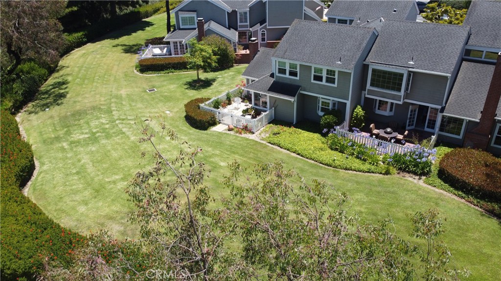 Located in one of the most premium locations on the Harbor View Knoll greenbelt, with wide open greenbelt and mountain views from every level. This light and bright residence features 2 bedrooms/2.5 bathrooms with vaulted ceilings, durable flooring throughout the main floor living areas, and a cozy fireplace that adds warmth and charm. The kitchen overlooks the beautiful greenbelt and mountain view, and includes recessed lighting, stainless steel appliances, creating an ideal space for cooking and entertaining. All bedrooms are located upstairs, including a spacious primary retreat with a bay window view of the greenbelt and mountains, ample closet space, and its own en-suite bath. Enjoy both a private patio and an upper deck—perfect for soaking in the sun or relaxing outdoors. With no neighbors behind, you’ll appreciate the added sense of privacy. Additional highlights include a private elevator for convenience and increased accessibility, central A/C, an attached two-car garage, and access to fantastic community amenities such as a pool, spa, and tennis courts. Ideally situated to nearby Newport Hills Shopping Center & Bonita Canyon Sports Park. Easy access to the 73 freeway and only minutes to Fashion Island, Corona Del Mar Village and beaches, the Bluffs Shopping Center, and Newport North Shopping Center! Also located within the highly-rated Newport Mesa School District, and zoned for award winning Andersen Elementary School. This is Newport Beach living at its finest!