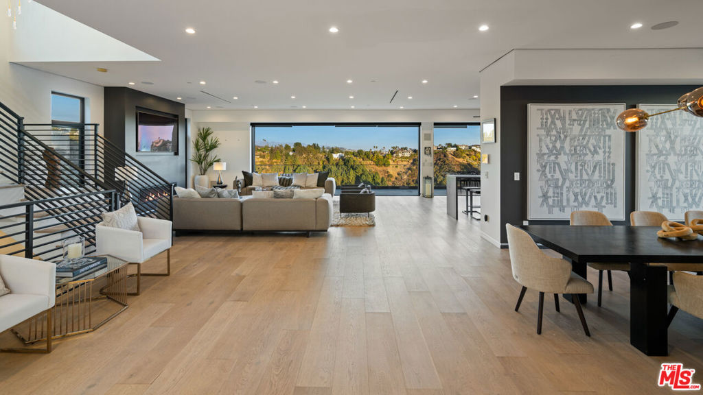 Experience the pinnacle of modern luxury in Bel Air with this 6,000-square-foot, 5 bed/7 bath architectural masterpiece with breathtaking ocean and city views. The grand entry with soaring 10-foot ceilings welcomes you into an expansive open floor plan with a seamless indoor-outdoor flow. Entertain in style from the chef's kitchen featuring Miele appliances, oversized center island and custom cabinetry. Take the private elevator to the lower level, boasting a state-of-the-art movie theater with a 130-inch projector screen and Sony HD projector, a curated wine cellar, custom-built bar, and seamless access to the zero-edge infinity pool. Retreat to the luxurious primary suite, and enjoy the stunning vistas from your private balcony or spa-inspired bathroom with freestanding Italian bathtub and dual vanity. Five additional beautiful appointed guest suites. Relax on the rooftop deck with mesmerizing panoramic views. Additional highlights of this exceptional home include a two-car garage with additional driveway parking and smart home technology featuring Sonos, Lutron, and Nest all easily controlled from your smart device. Situated in one of L.A's most coveted enclaves, this residence offers not only unparalleled luxury but also proximity to the city's finest dining, shopping, schools and cultural attractions.