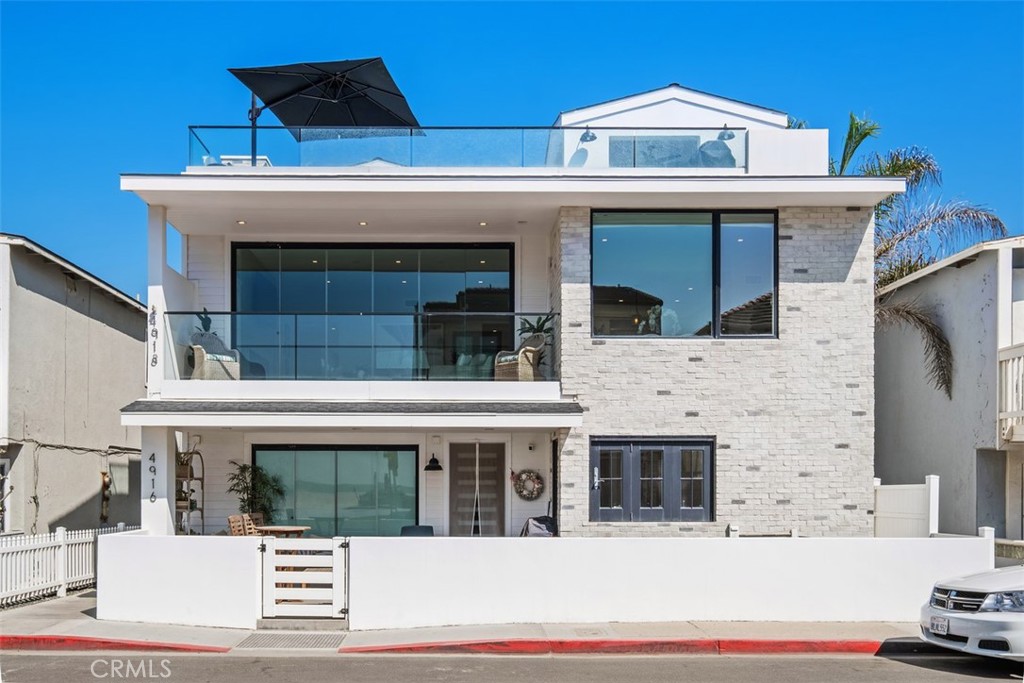 Experience luxury coastal living at its finest in this newly built 2022 masterpiece, located just one house off the sand on the coveted strand of Seashore Drive in Newport Beach. Set on an oversized 40-foot-wide lot, this rare coastal gem offers approximately 2,800 square feet of impeccably designed living space. The four-bedroom, five-bath residence captures panoramic sit-down ocean and whitewater views from every level.
Thoughtfully crafted with the finest finishes and modern comforts, the home showcases an open-concept floor plan highlighted by floor-to-ceiling glass that maximizes natural light, sweeping views, and the seamless indoor-outdoor coastal lifestyle. The gourmet kitchen is appointed with custom cabinetry, quartz stone countertops, chef-grade appliances, and a large island ideal for entertaining.
Each bedroom suite is designed for comfort and privacy, while the spa-inspired baths feature premium fixtures and materials. The residence also includes a private three-stop elevator, a two-car garage with additional parking, and smart home integration throughout. The primary suite comes complete with dual bathrooms and generous walk-in closets.
Seldom used and maintained as a summer second home, this property feels virtually brand new. Ideally situated steps from the beach and just one minute from Pacific Coast Highway, you’ll enjoy convenient access to Newport’s best restaurants, boutique shopping, and world-class surf breaks.
Homes in this highly desirable “gap” location with unobstructed ocean views rarely come available—don’t miss this opportunity to own a modern coastal showpiece in one of Newport Beach’s most sought-after neighborhoods.