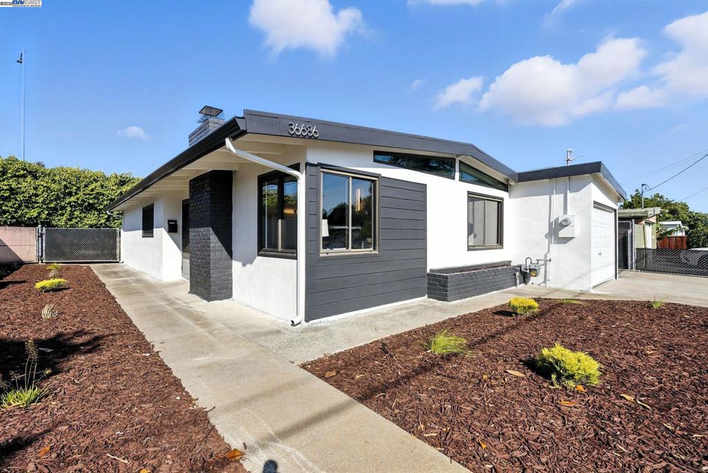 Sleek, stylish & fully renovated! This Mid-Century Modern 3BD/2BA in Newark blends architectural charm with modern upgrades. Permitted updates include new roof, furnace, water heater, kitchen & baths. Enjoy vaulted open-beam ceilings, designer finishes, and abundant natural light across 1,190 sq ft of reimagined living space. The galley kitchen features shaker cabinets, quartz counters, and stainless appliances. On a spacious 5,500 sq ft lot with private outdoor living, a vine-covered pergola, and side access for RVs, boats, or 6–8 cars—ideal for entertaining or future ADU. Prime location near Lakeshore Park with quick access to Hwy 880, Dumbarton Bridge, and major tech hubs across the Peninsula and South Bay. Minutes to restaurants, shopping, and everyday essentials. Turnkey living with style and convenience!
