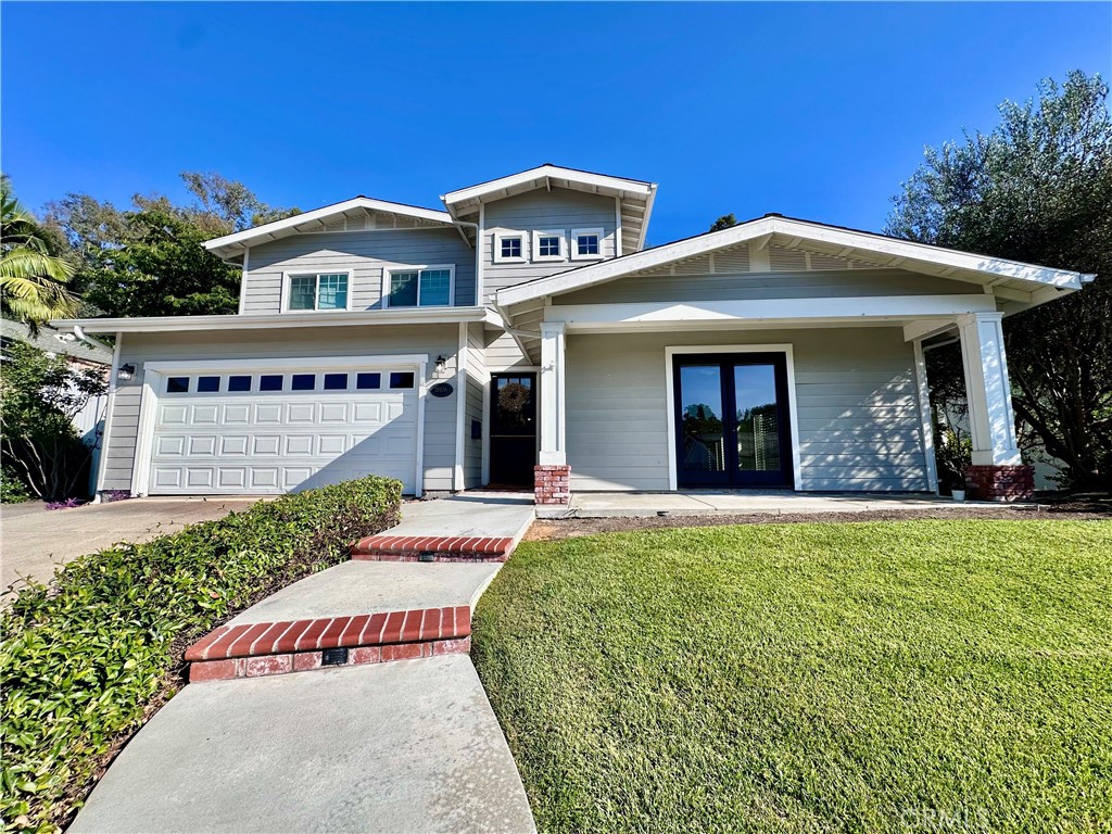 This home is unlike any other that you have seen. It is perfect for multi-generational living, has a large yard with mature landscaping, and the back yard is so private, you won't even know that you have neighbors. Upgraded with high end finishes that include hardwood floors, plantation shutters, stainless appliances, wine refrigerator, an open floor plan with tons of space and so much more! The main level of this home features the upgraded kitchen with granite counters and stainless appliances, family room, 3 secondary bedrooms, and 2 full bathrooms. One downstairs bedroom could be used as a master if a main floor master is needed or used as a bonus room or incredible flex space. The window in the front of this room will be replaced with French doors that open to the front patio, for a truly inviting indoor/outdoor living experience. Upstairs is the office and enormous master suite complete with a luxurious marble master bath, and dual walk in closets. All this and a well maintained back yard with above ground spa. Tastefully hardscaped with terraced grassy space, fire pit, and fruit trees. This truly is a one of a kind property. Conveniently located close to shopping, freeway, and toll road.