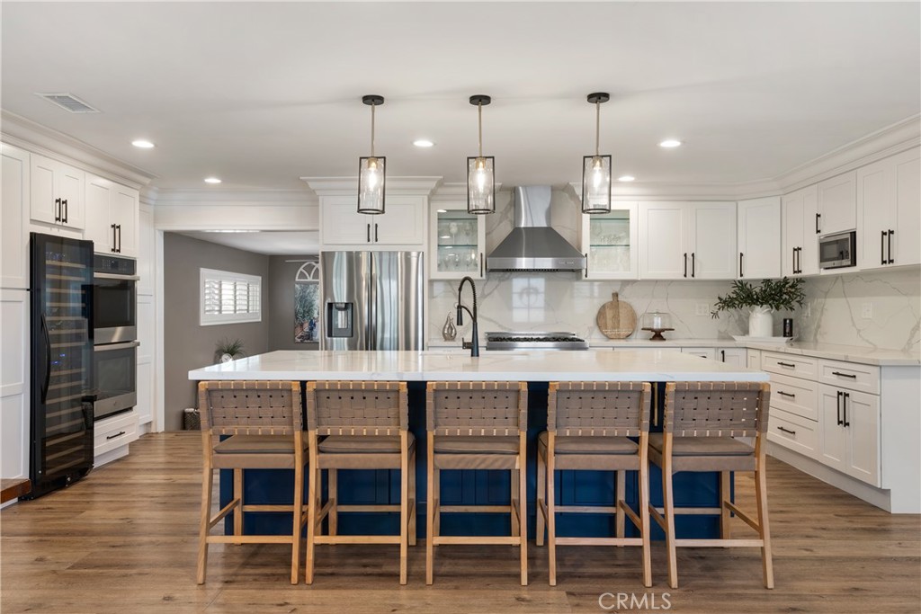 Nestled in one of Long Beach’s most coveted neighborhoods, this completely remodeled 6-bedroom, 3-bath home offers the perfect combination of luxury, comfort, and functionality. Set on a spacious 6,074 sq ft corner lot, this 2,825 sq ft home has been thoughtfully designed with modern upgrades and energy-efficient features to meet today’s buyer’s needs.
From the moment you enter, you'll be greeted by a bright and airy open floor plan, perfect for entertaining and everyday living. The gourmet kitchen is a true chef's dream, complete with premium stainless steel appliances, a Z-Line 6-burner gas range, double wall oven, wine fridge, custom wine rack, and a generous center island that opens to the oversized living and dining areas. The layout is perfect for hosting gatherings or enjoying quiet family moments.
The first floor offers two versatile bedrooms, one of which has been converted into an indoor laundry and office space (with original hookups in the garage for easy conversion back to a bedroom). A beautifully remodeled three-quarter bath with a walk-in shower, custom vanity, and elegant marble tile completes the main level.
Upstairs, the primary bedroom offers a spacious walk-in closet and serene views of the neighborhood. Three additional bedrooms and two full bathrooms, each with double vanities and tub/shower combos, provide plenty of room for family or guests.
Additional highlights include:*Fully paid-off 21-panel solar system for energy savings and sustainability*Level 2 EV charger in the garage, perfect for eco-conscious buyers*Extended driveway with room forRV parking*Brand new front porch and shutters throughout*Indoor laundry and ample storage*Covered patio for year-round outdoor dining and entertaining*Recent backyard upgrades, ideal for relaxation or outdoor activities*Located in a top-rated school district and close to local parks, shops, and dining*
This home underwent a full renovation in 2019/2020, blending modern upgrades with timeless charm. Whether you’re ready for more space to grow, need a home office, or are looking for a multi-generational living solution, this home offers the flexibility and luxury you need. With its sustainable features, spacious layout, and convenient location, this is a rare opportunity to own a piece of Southern California’s best living.
Don’t miss your chance to see this Los Altos gem—schedule a private showing today!